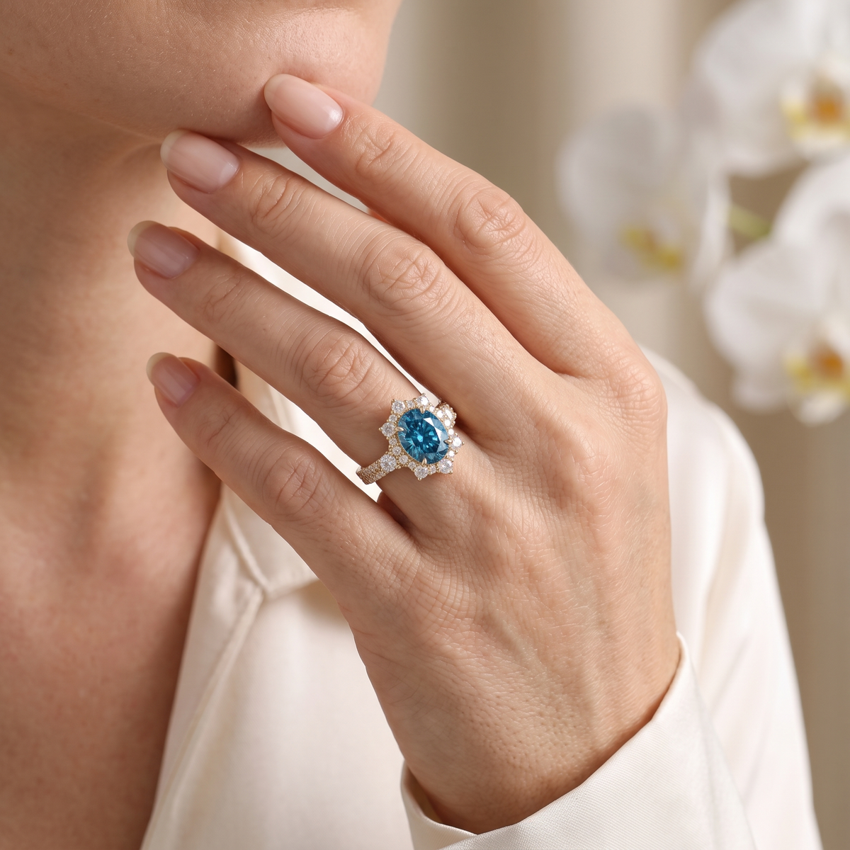Close-up of a model wearing the rose gold oval blue moissanite halo ring with pavé band.