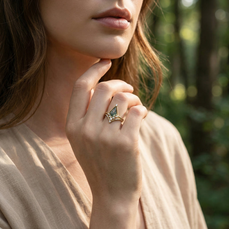 Model wearing the gold-plated moss agate pyramid ring set on her finger in a natural forest setting.