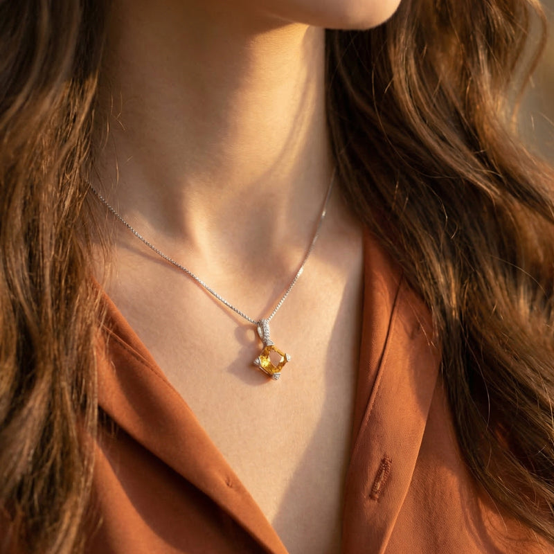 Model wearing the Aurestia natural citrine necklace in silver, highlighting the square-cut gemstone's honeyed warmth.