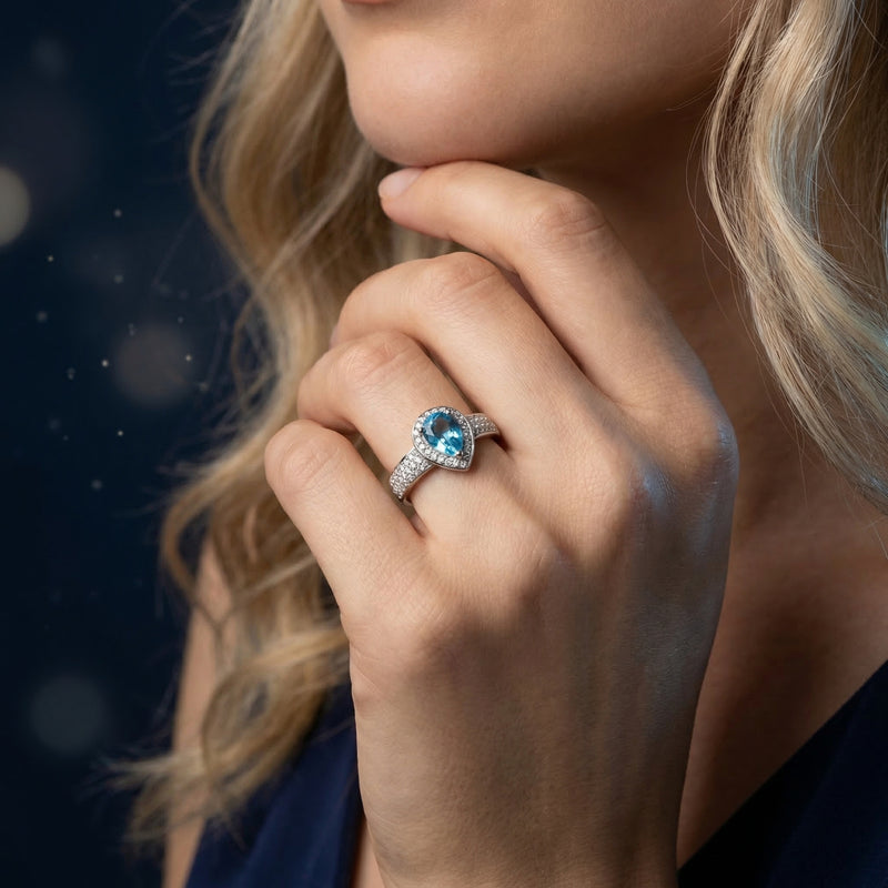 Mariana pear cut Swiss blue topaz ring in sterling silver worn on a model's hand.