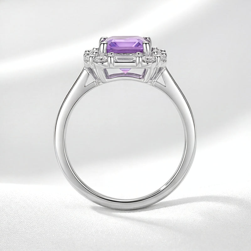 Side profile of the S925 sterling silver Veridiana halo ring with an emerald cut simulated amethyst.