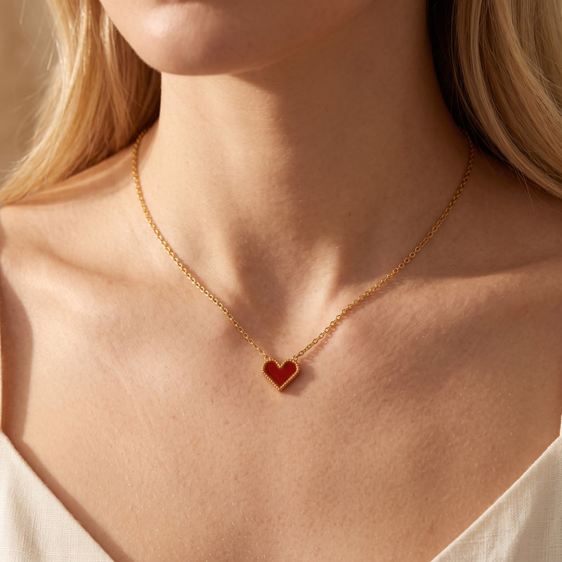 Lylia scarlet heart necklace in 18K gold PVD finish worn by a model.