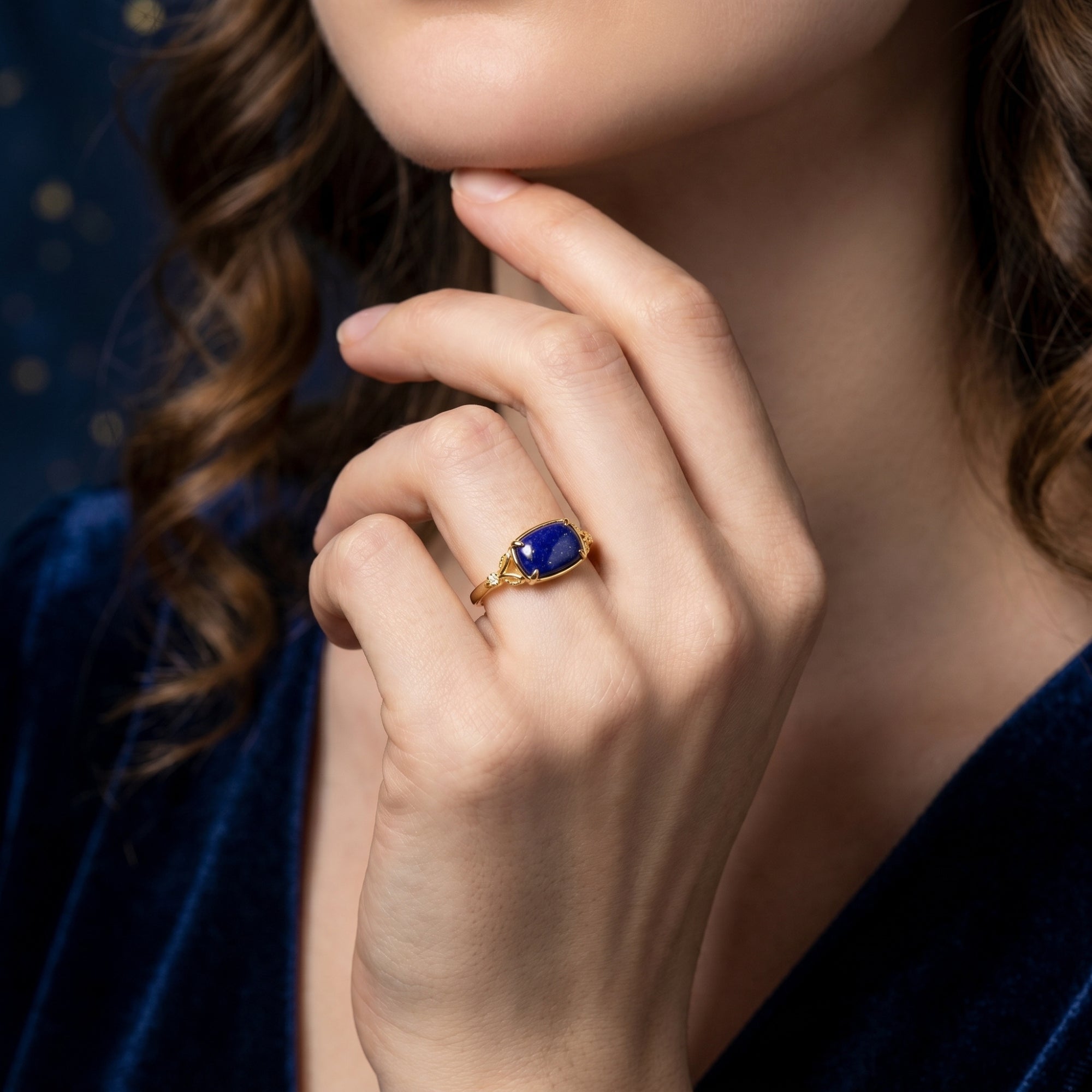 Model wearing the yellow gold Alexandria natural lapis lazuli signet ring on her finger.