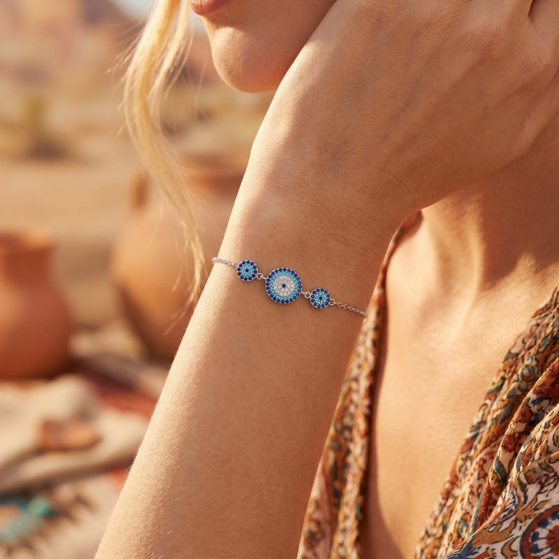 Model wearing the Paloma turquoise silver bracelet with three blue pavé circular charms on her wrist.