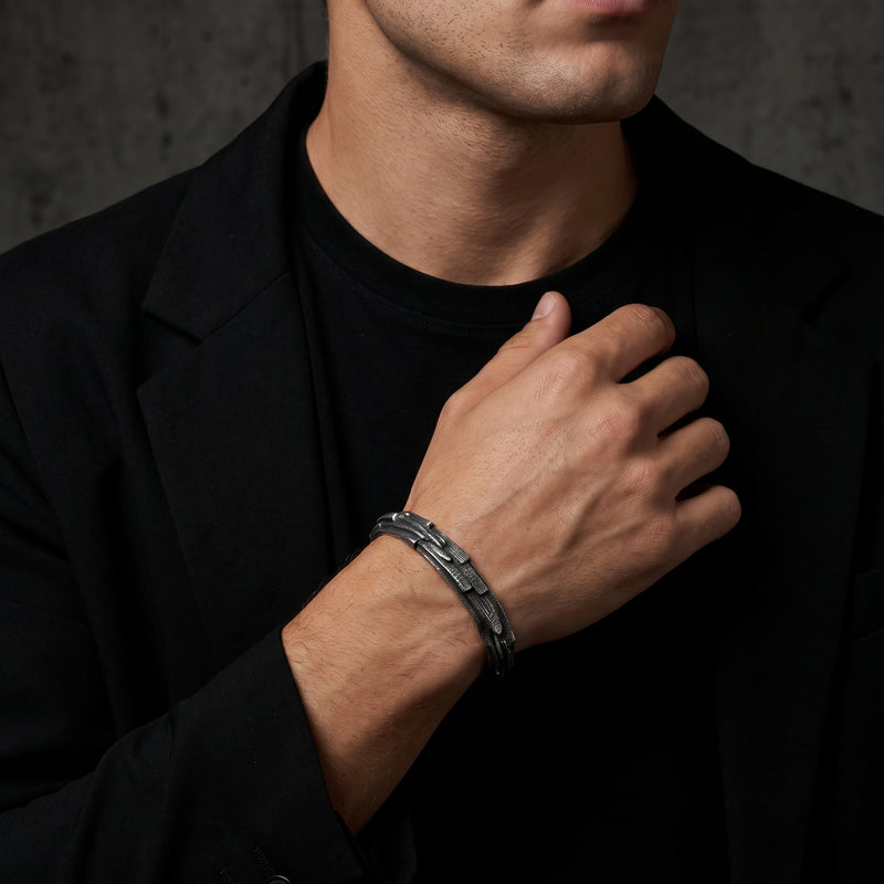 Model wearing the textured silver cuff bracelet on his wrist with a black blazer and T-shirt.
