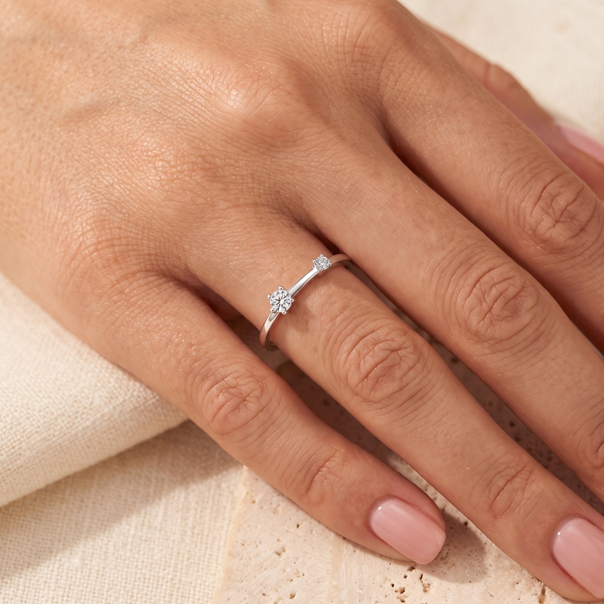 S925 sterling silver asymmetric bypass ring with simulated diamonds worn on a hand.