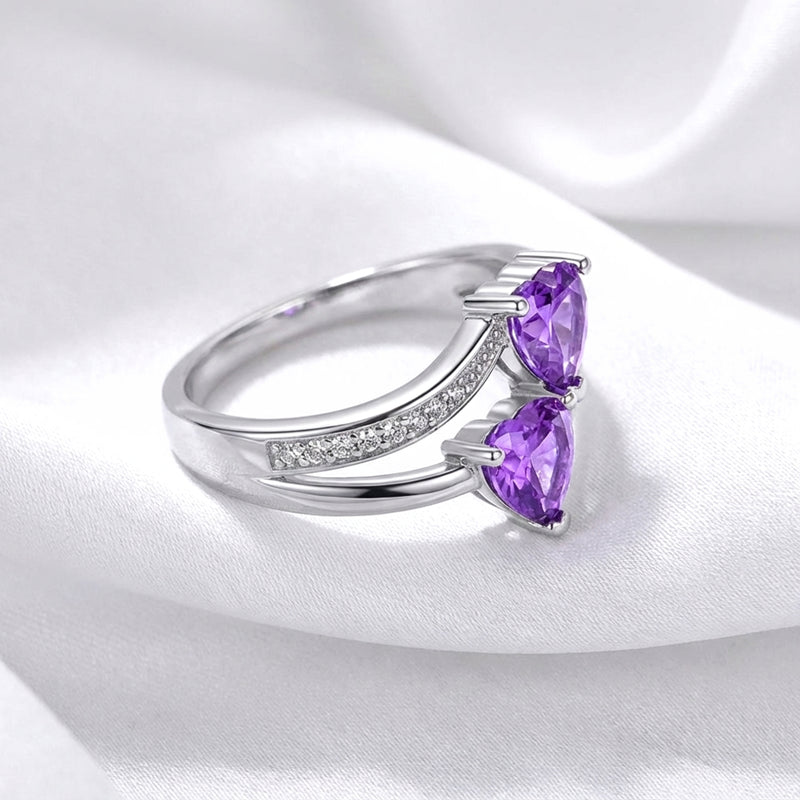 Angled side view of the S925 sterling silver Adara ring showing the bypass setting and simulated amethysts.