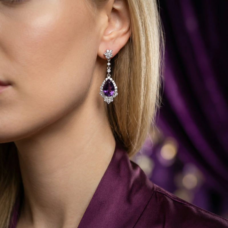 Model wearing a pear cut natural amethyst drop earring in S925 sterling silver.