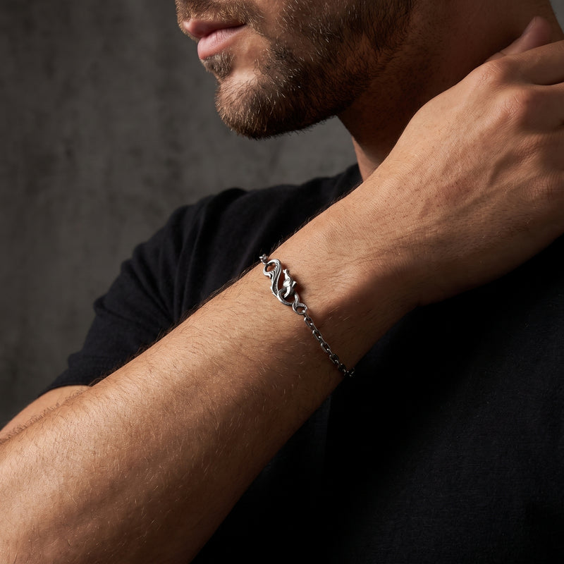 Person wearing the silver dragon chain bracelet on the wrist, with the dragon clasp visible near the neck.