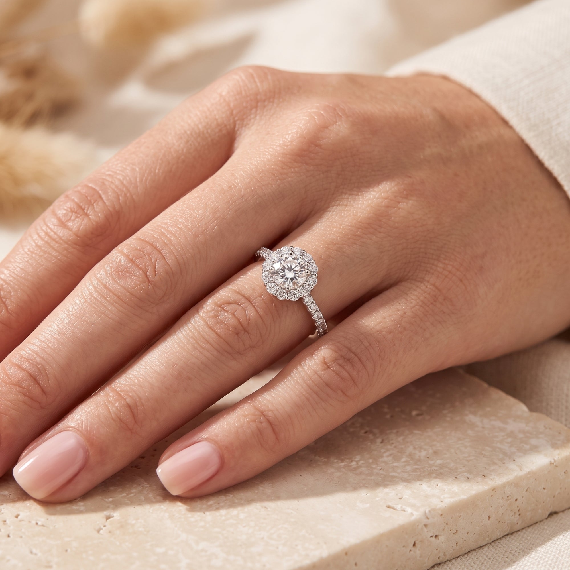 Close-up of a woman's hand wearing the S925 silver floral halo promise ring with a round-cut center stone.