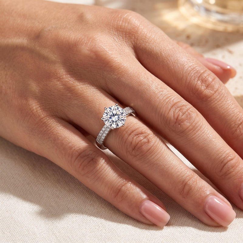 Sterling silver round-cut simulated diamond ring worn on a woman's hand.