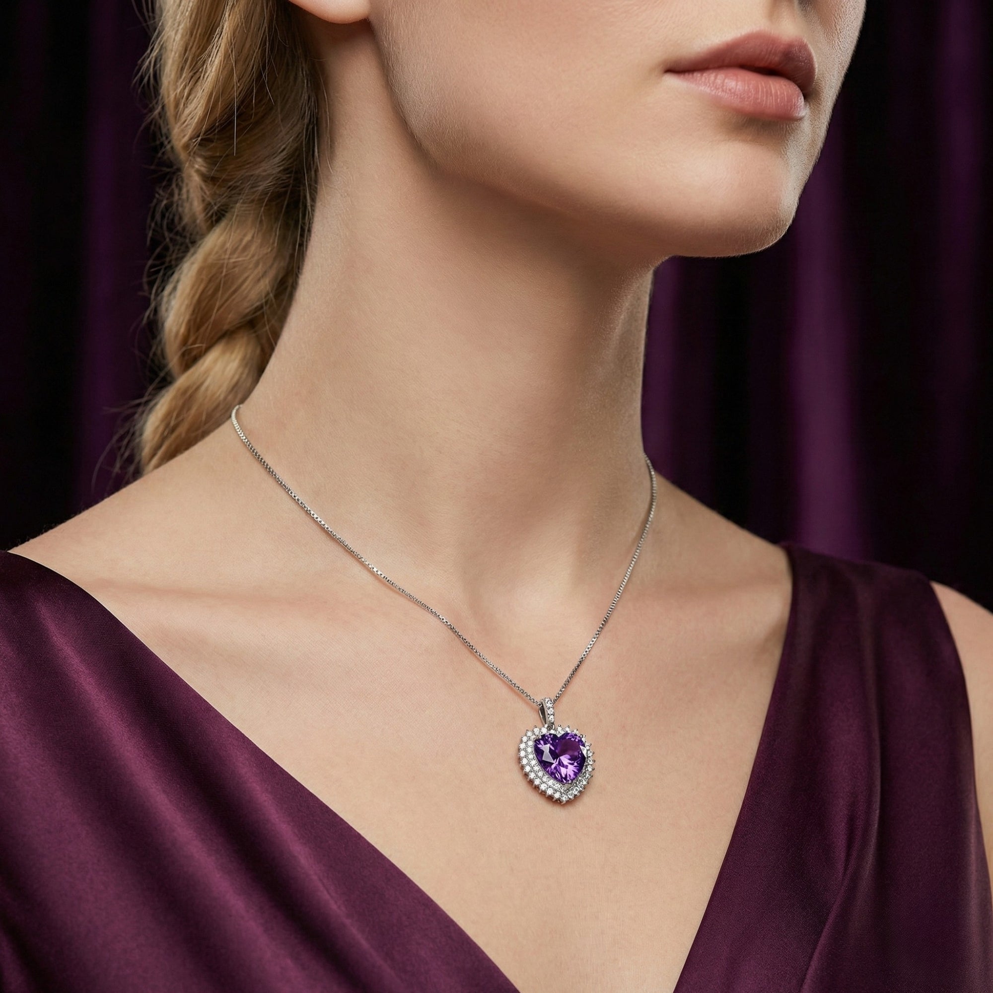 Woman wearing the Amalia heart-cut amethyst pendant in sterling silver on a delicate chain with a purple dress.