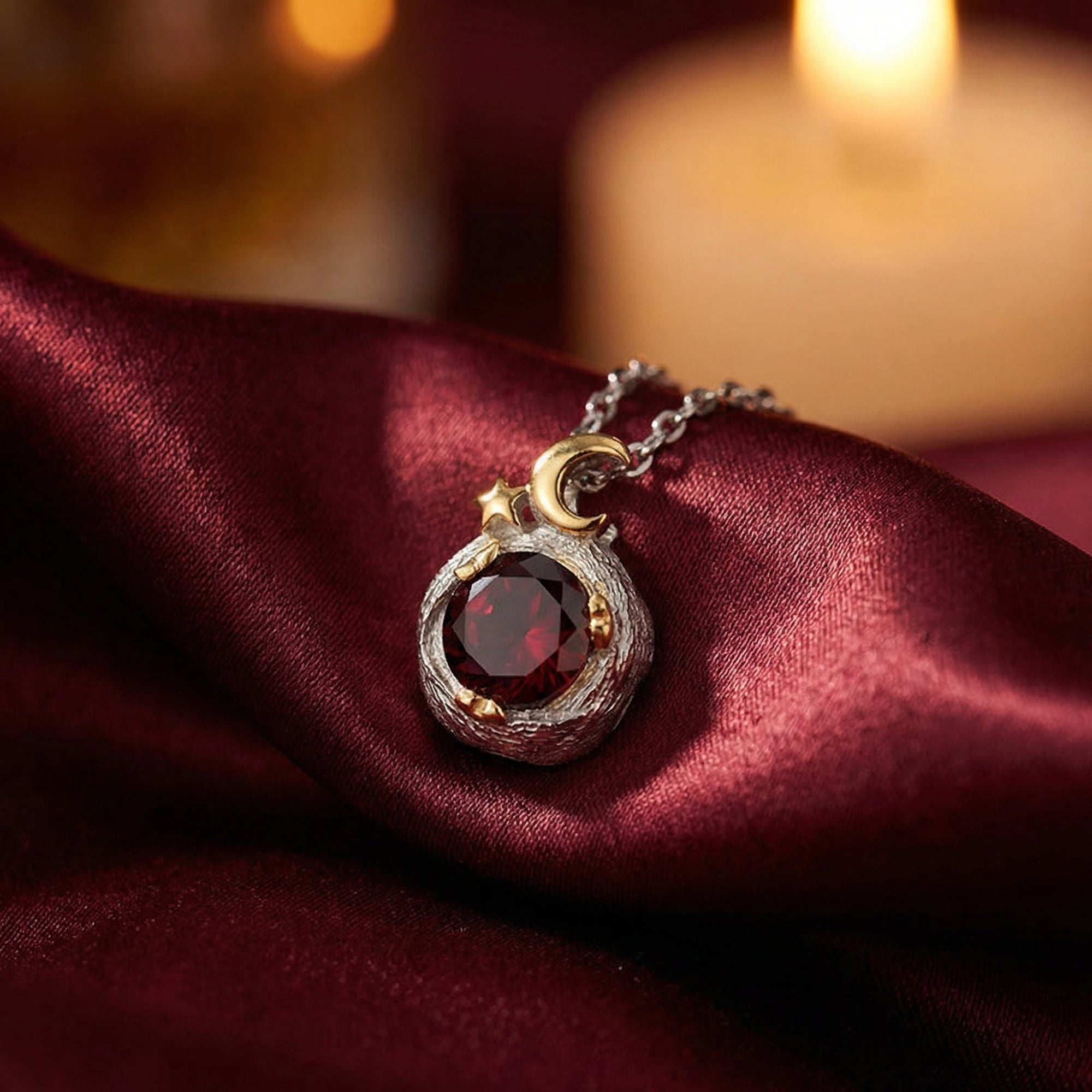 Macro view of the 1CT round natural garnet pendant featuring a textured silver setting and gold moon accent.