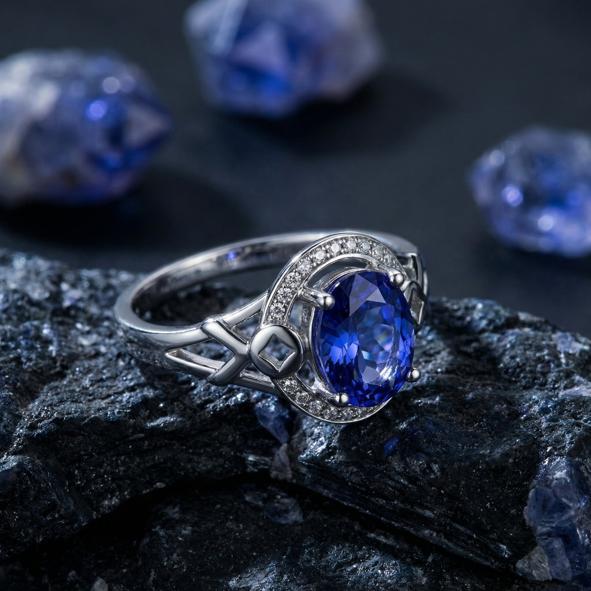 Close-up of the 18K white gold Alysandra ring featuring an oval cut tanzanite and intricate diamond-set band.