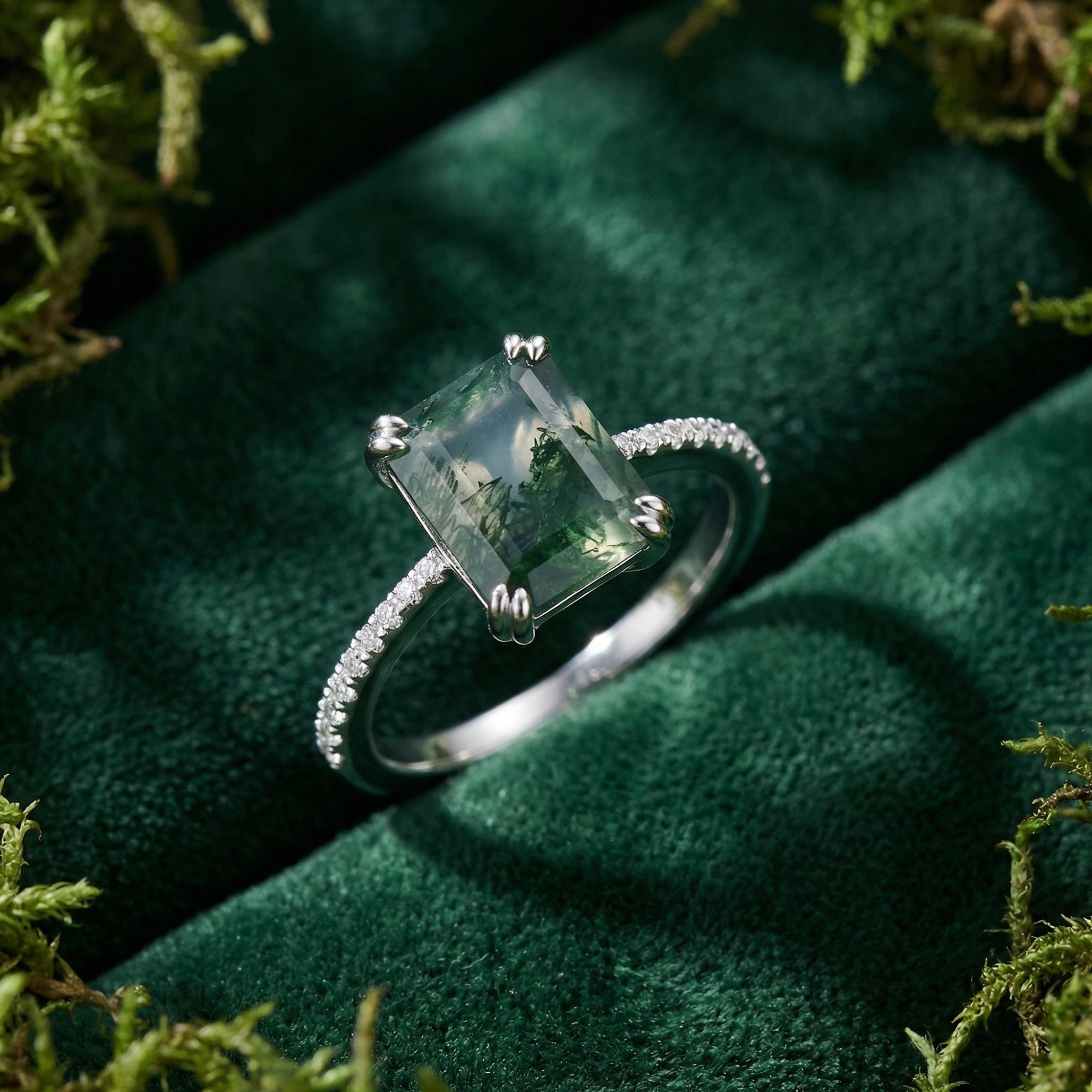 Macro view of a rectangular moss agate ring in S925 sterling silver showing the pavé diamond band and stone details.