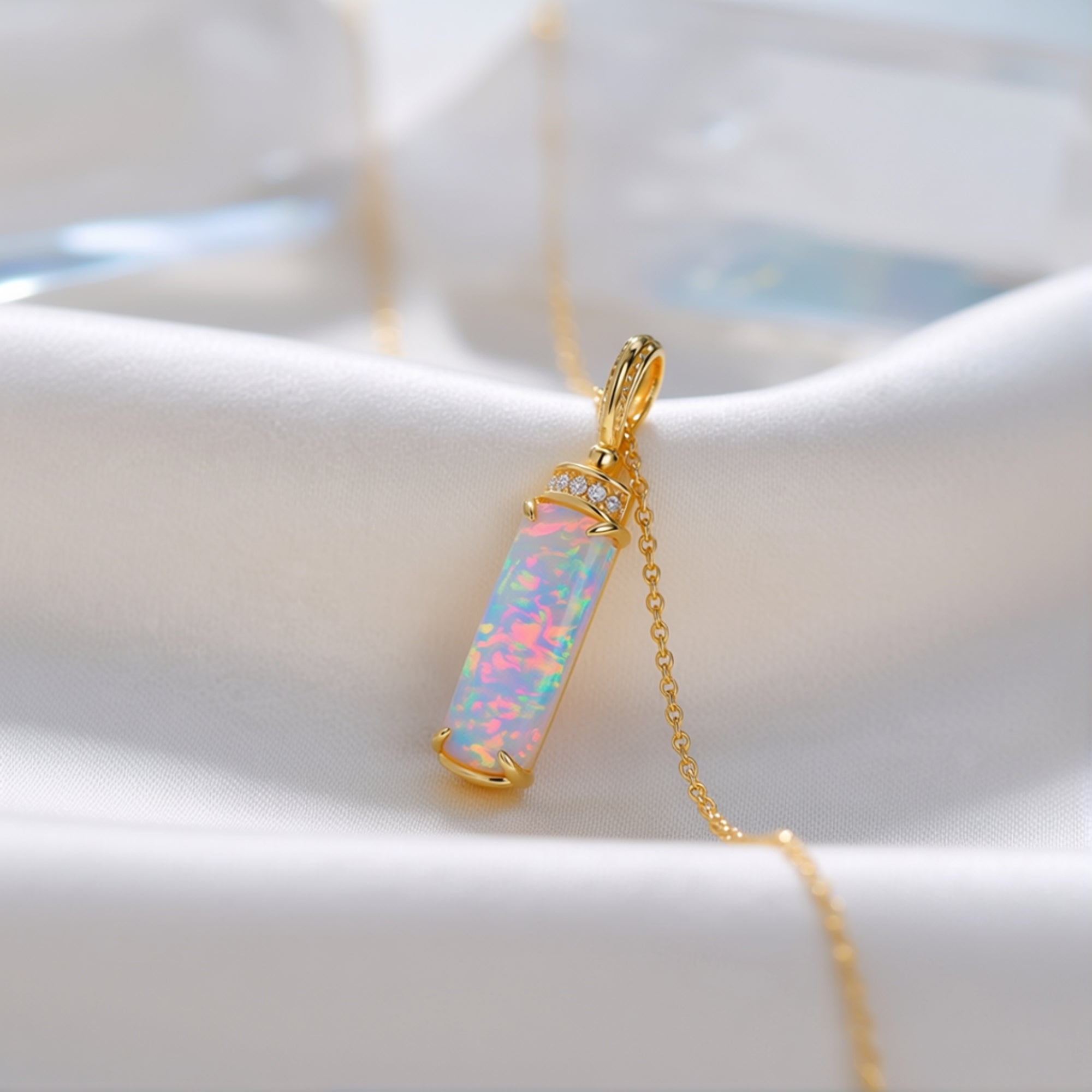 Close-up of the Galatea column necklace showing the iridescent white opal and gold-tone sterling silver setting.