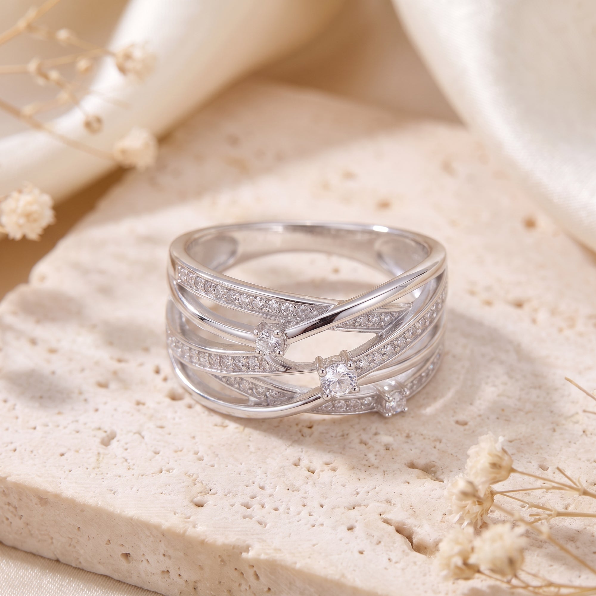 Close-up of a sterling silver multi-row crossover ring with pavé cubic zirconia.