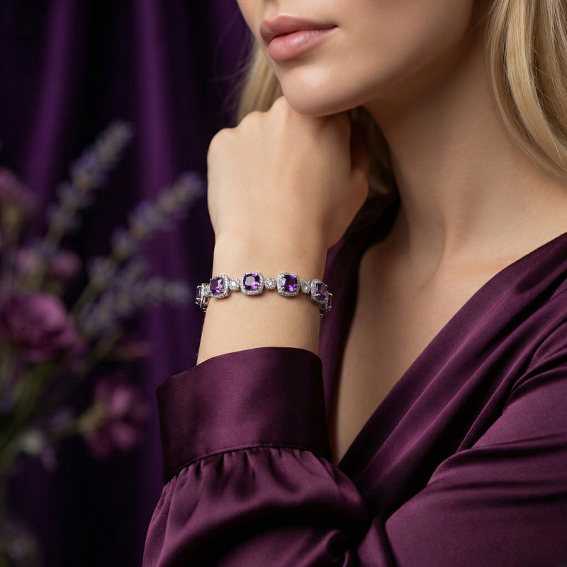 Woman wearing the cushion cut amethyst sterling silver bracelet on her wrist with a purple silk dress.