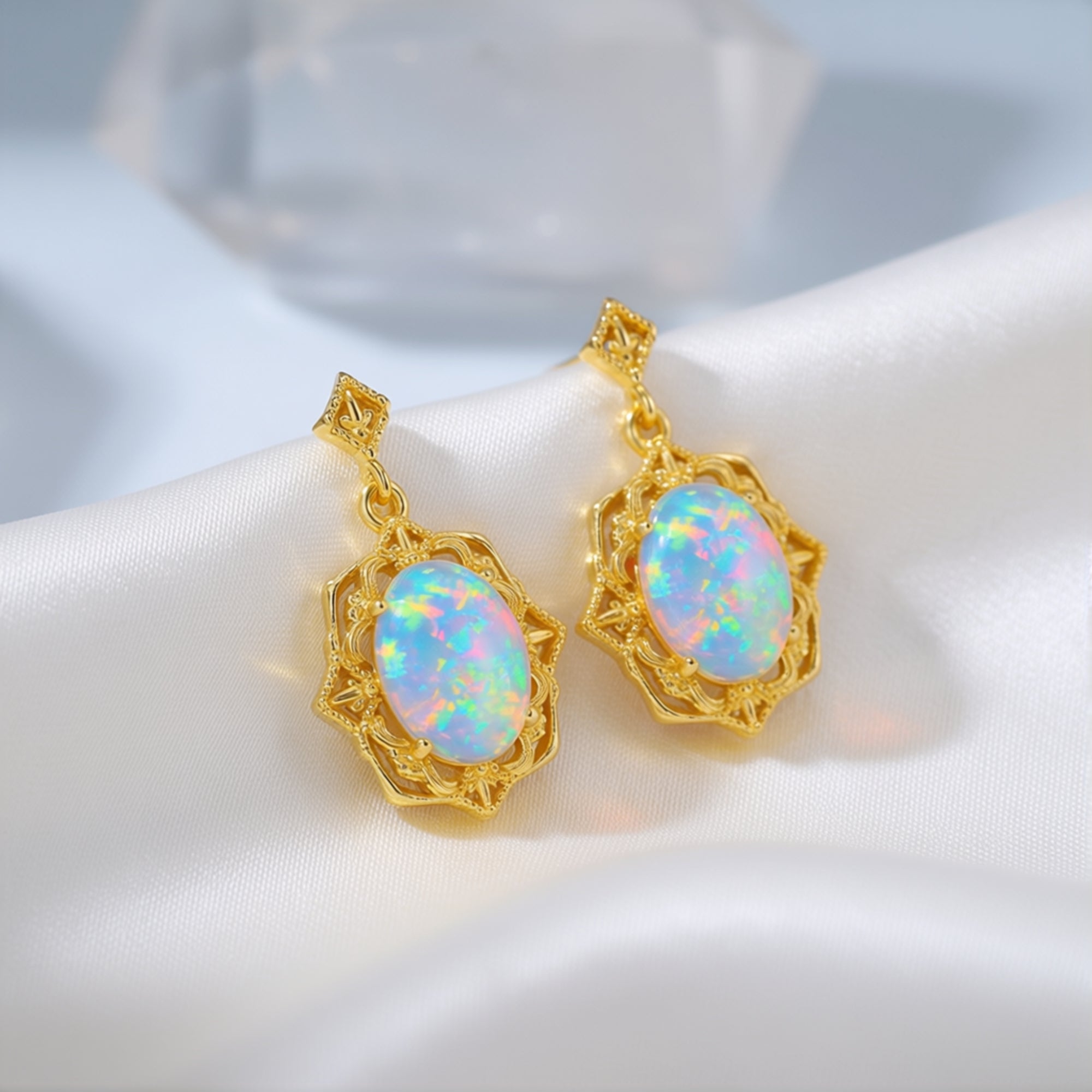 Close-up of gold-tone S925 silver drop earrings showing the intricate filigree and oval white opal stones.