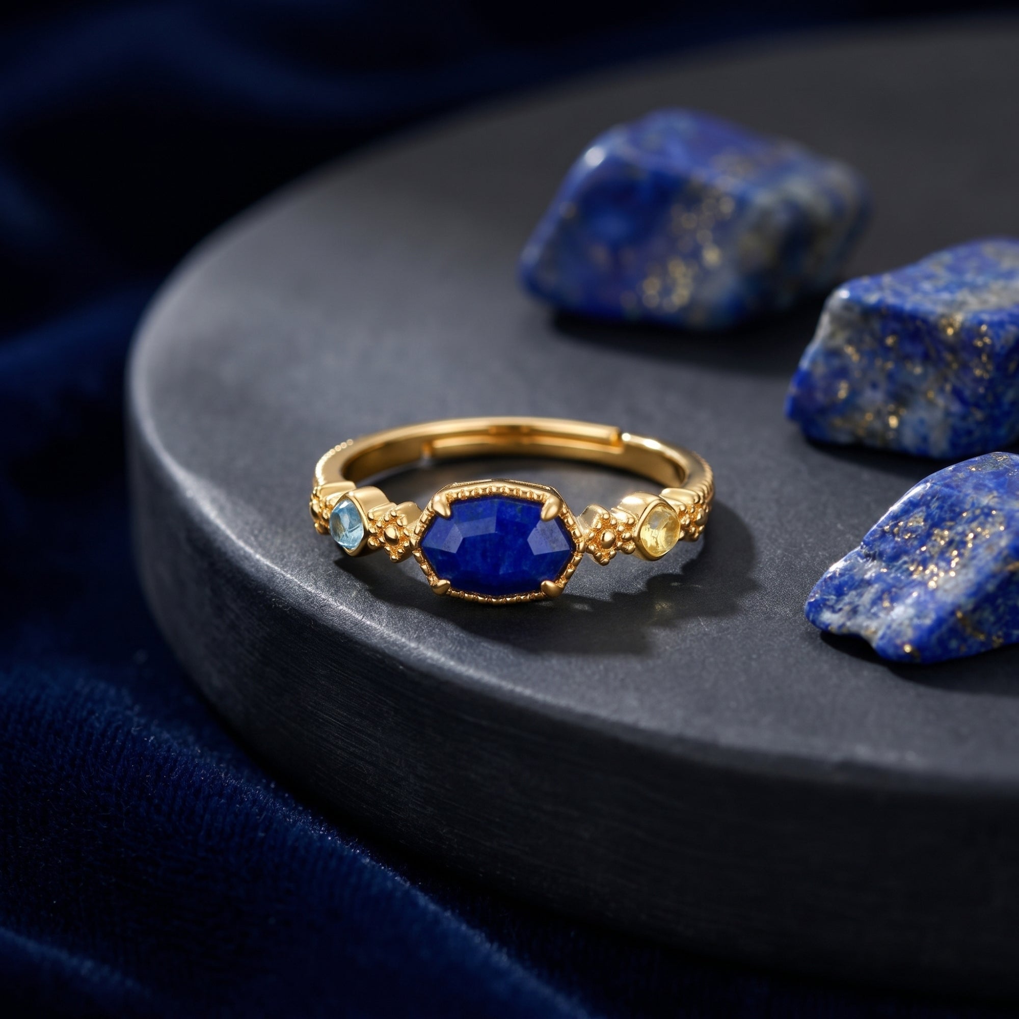 Close-up of the gold Lazuria ring showing the irregular cut lapis lazuli and colorful accent stones.
