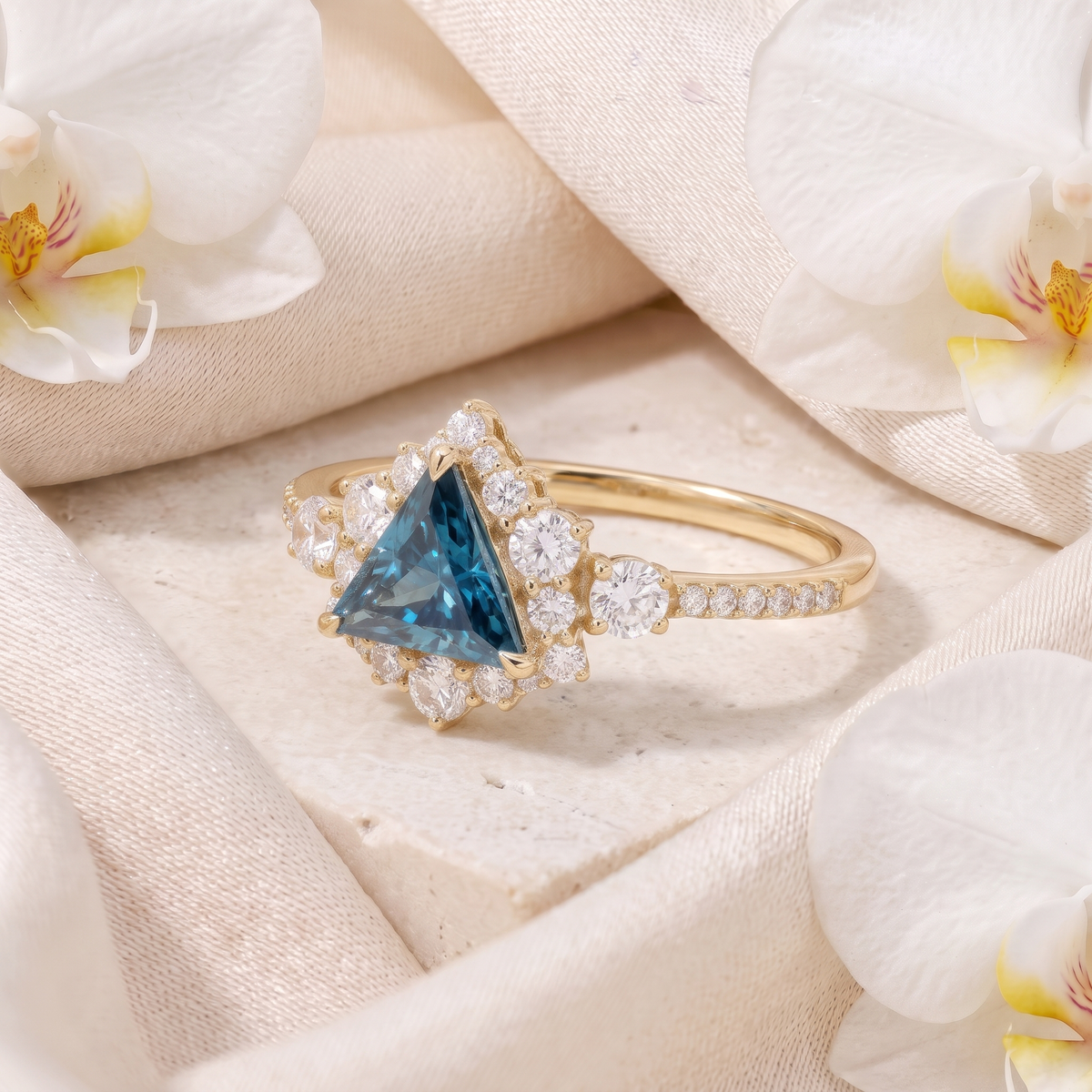 Angled view of yellow gold triangle cut blue gemstone ring with halo.
