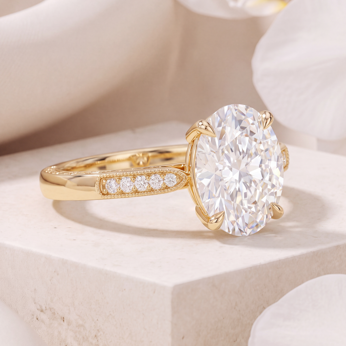 An angled profile view of an oval-cut moissanite ring on a yellow gold band featuring side diamonds.