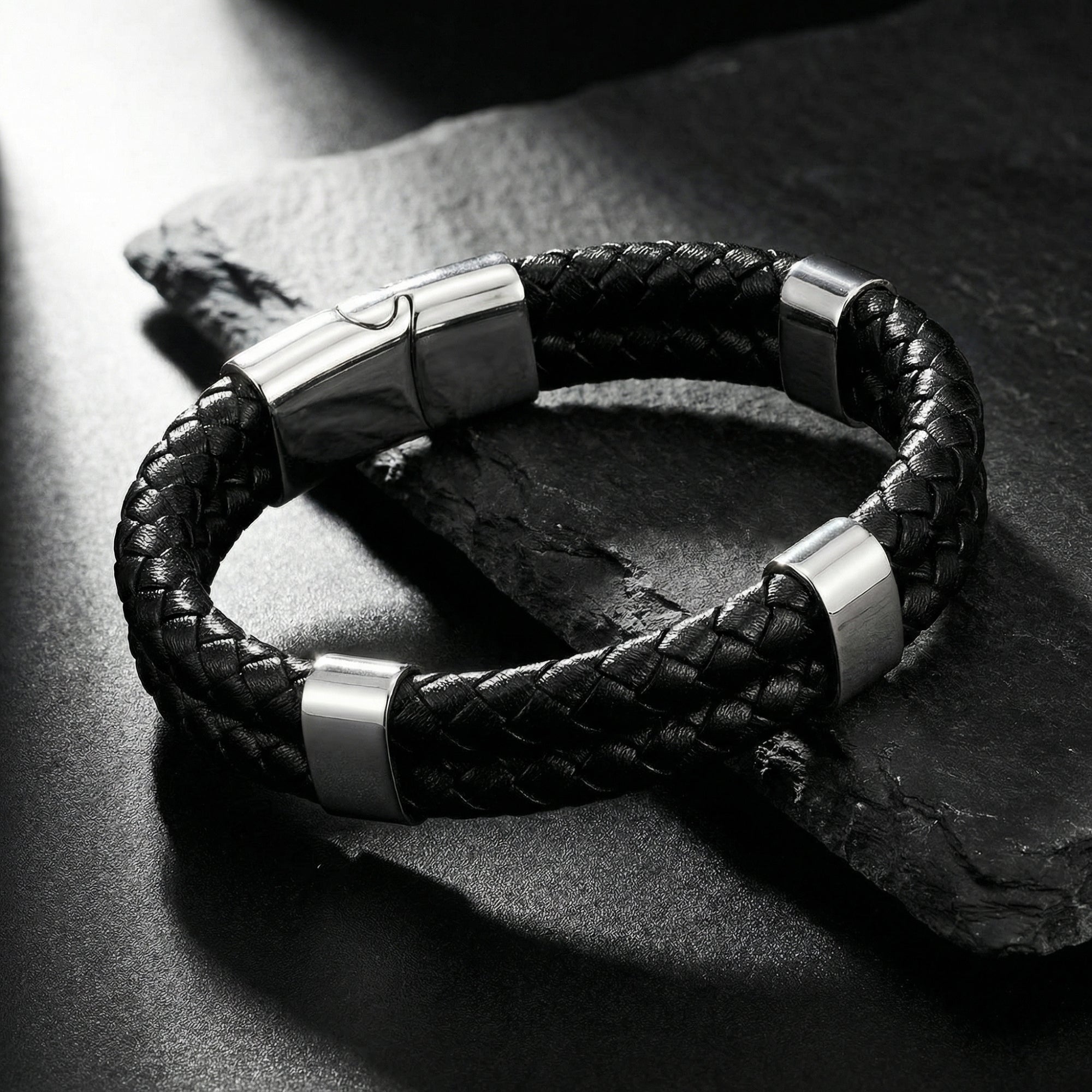 Detail of the silver 316L stainless steel integrated clasp on the black double-braided leather Sentinel bracelet.