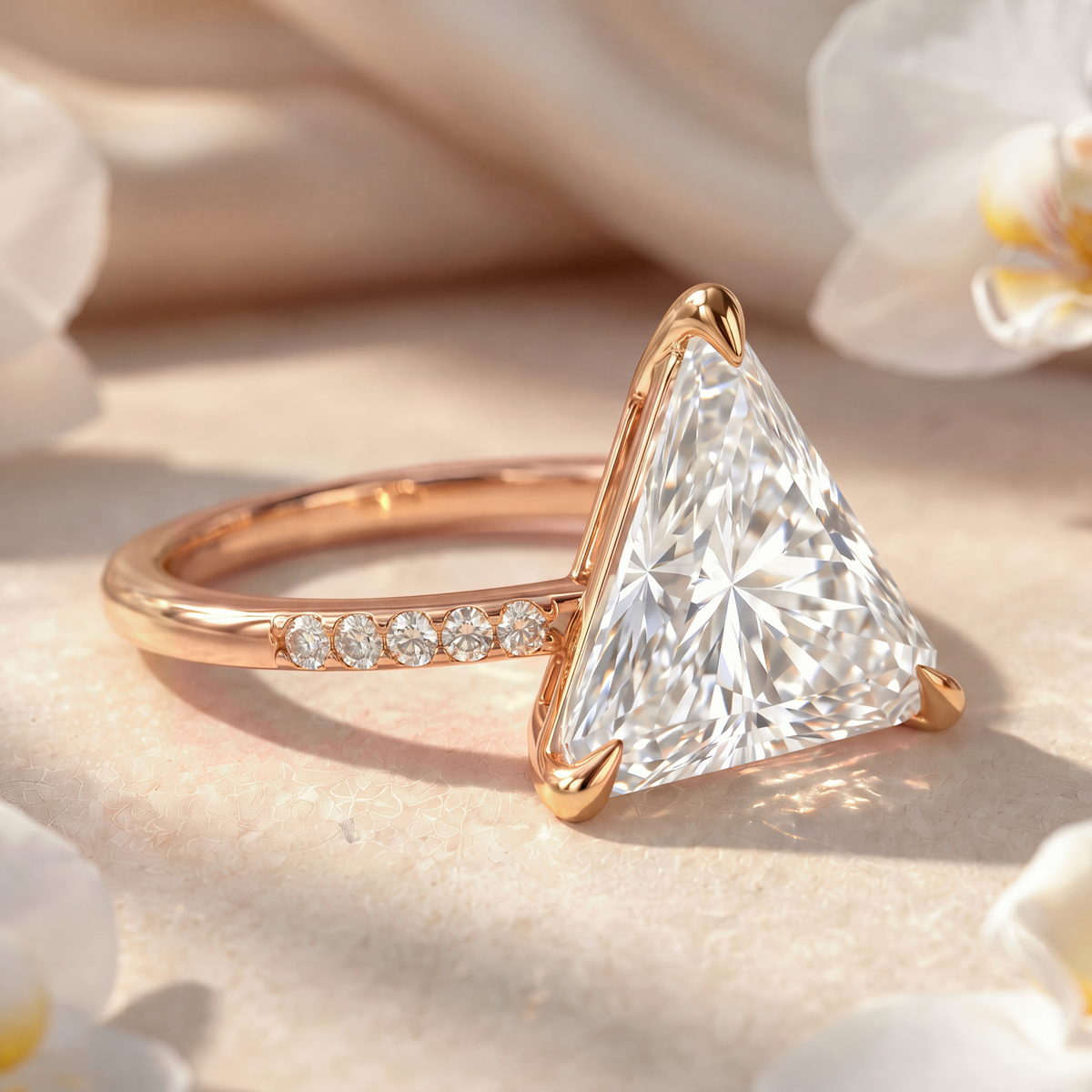 Side angle view of a yellow gold trillion-cut moissanite ring highlighting setting details.
