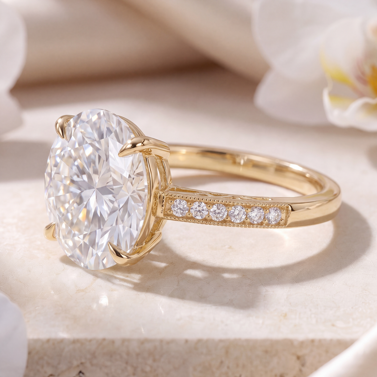 Side angle view showing the basket setting and milgrain pave band of a yellow gold oval moissanite ring.