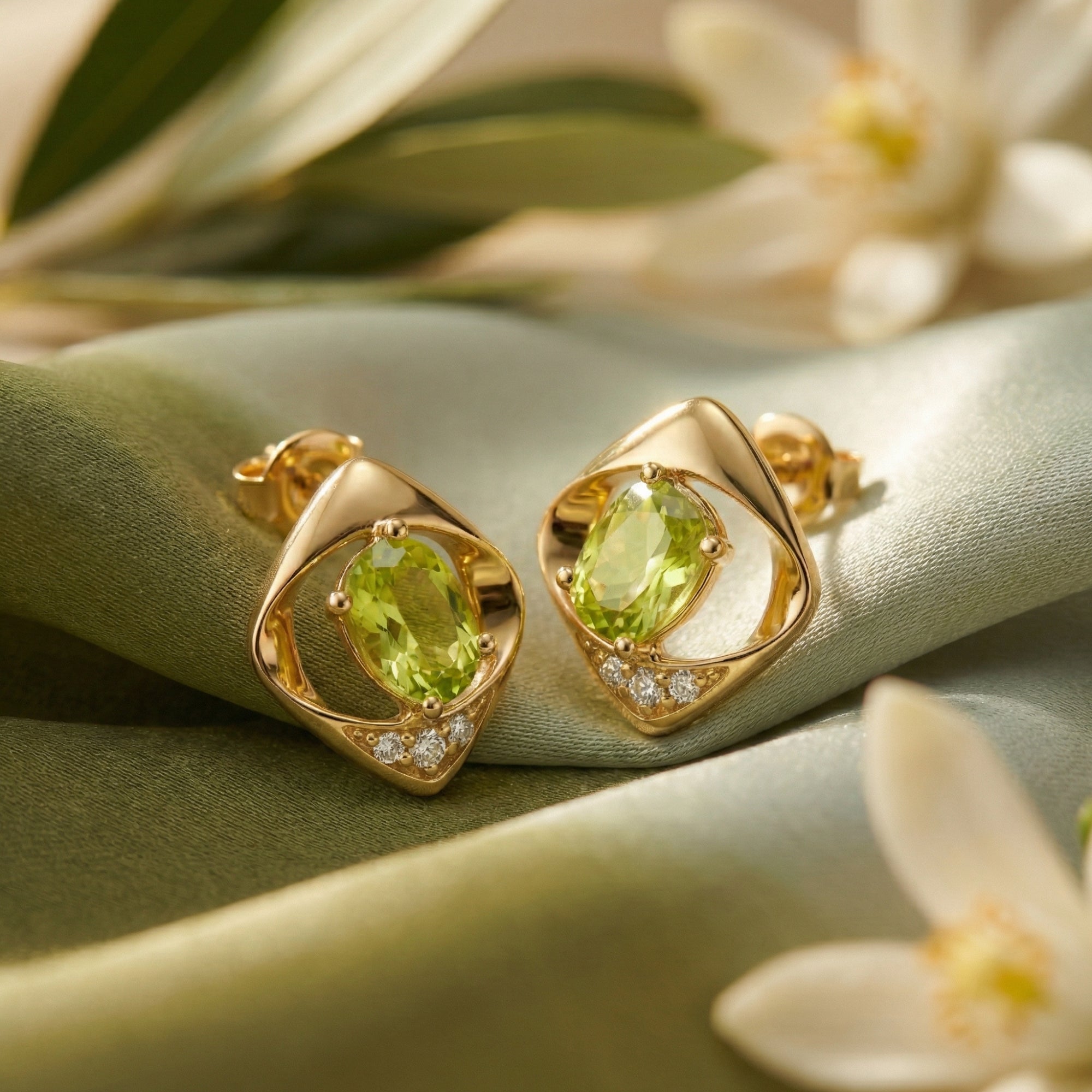 Close-up of gold vermeil Yvaine studs showing the oval cut peridot, accent stones, and butterfly backings.