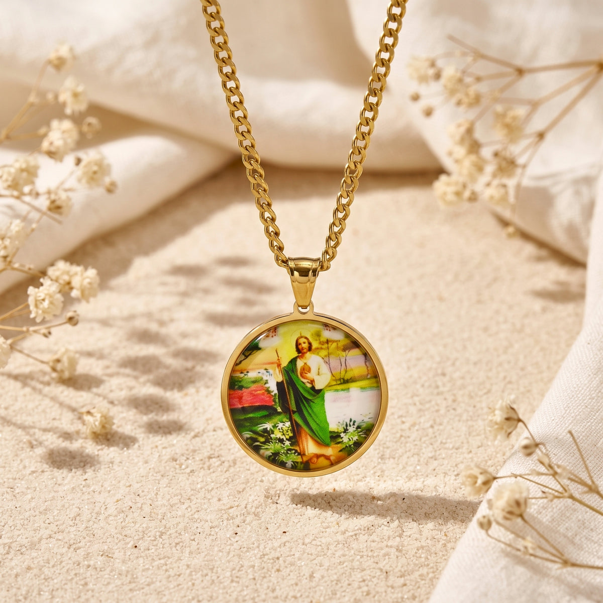 Close-up of the gold-tone St. Jude medallion pendant hanging straight on a curb chain.