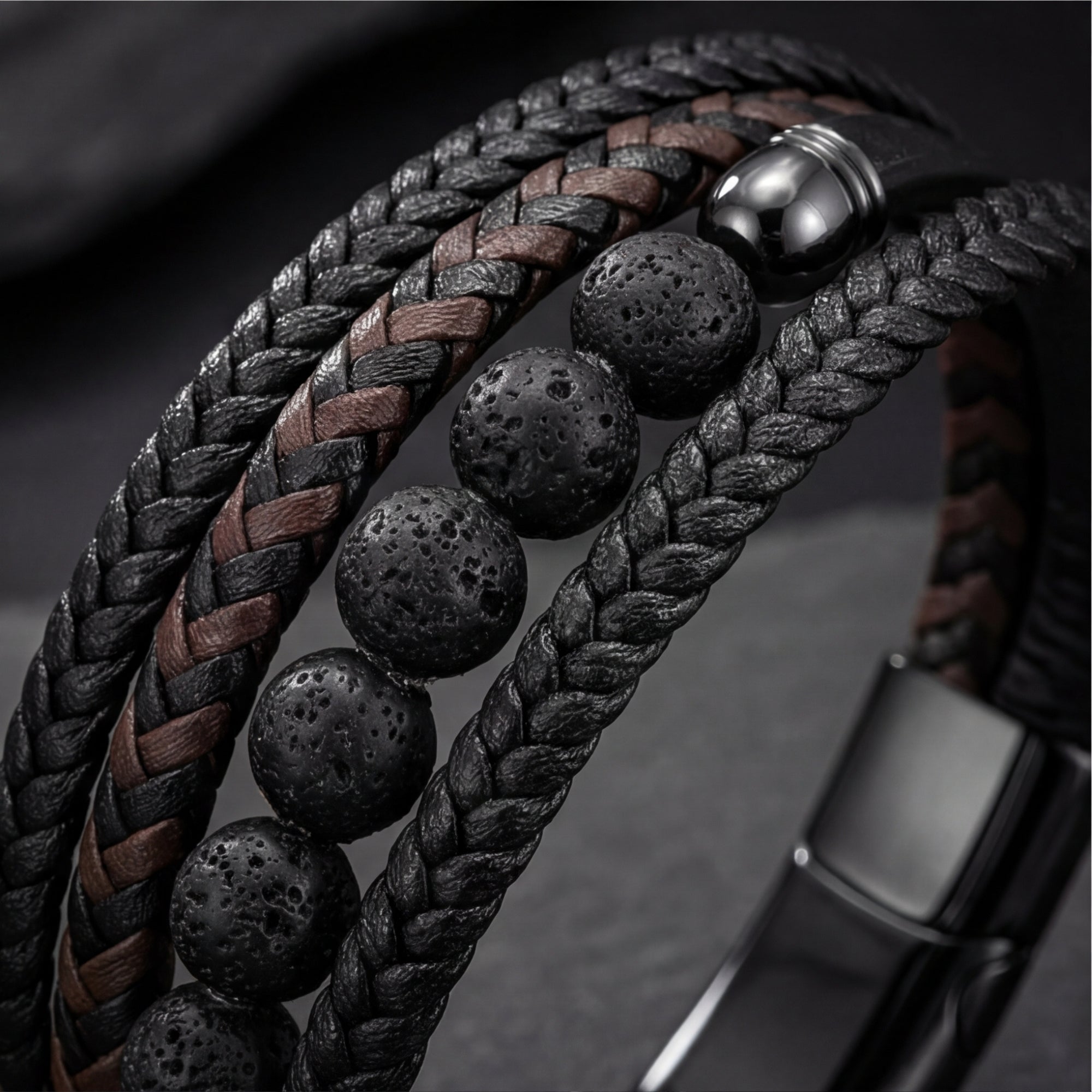 Macro view of the black braided leather and textured lava stone beads on the Outrider men's bracelet.