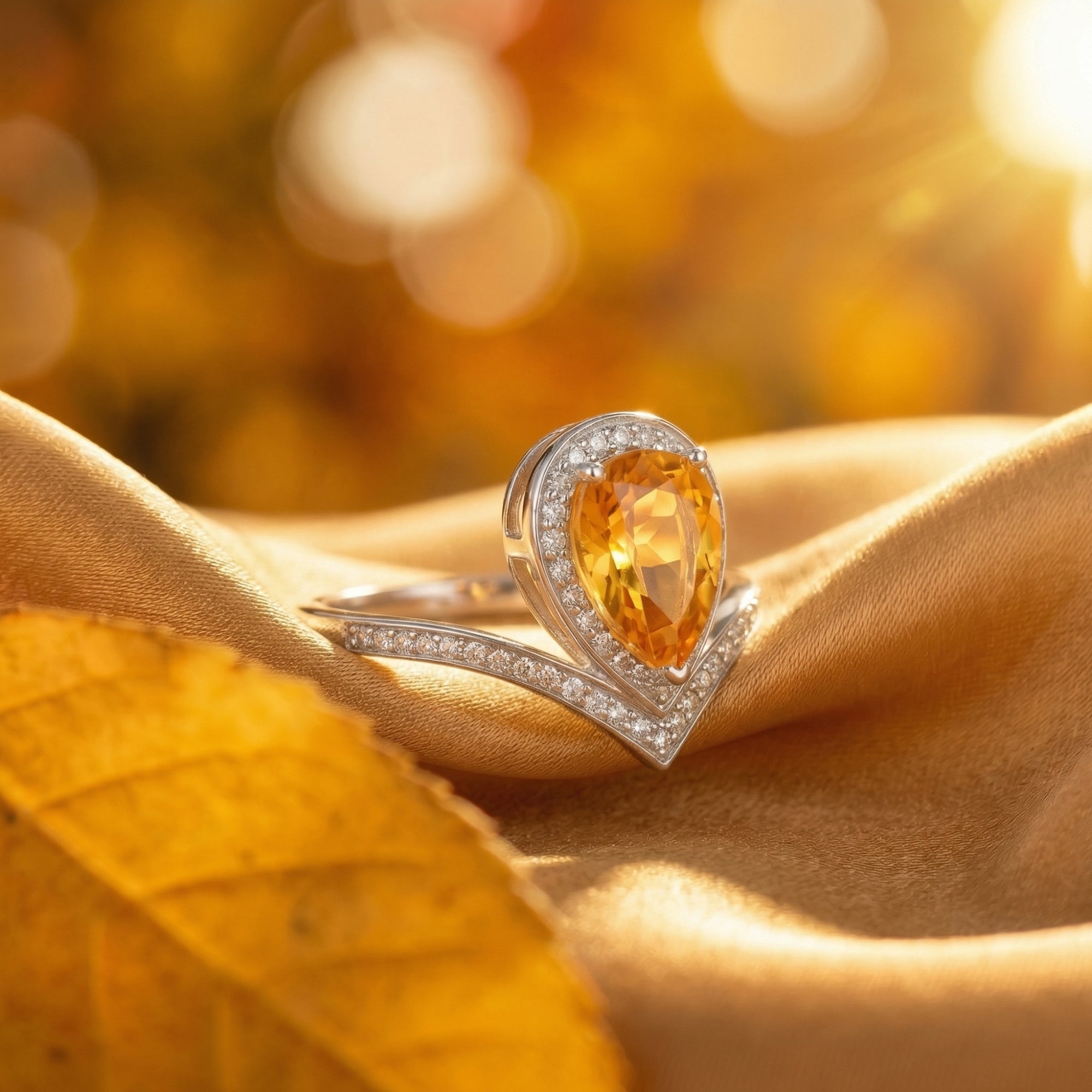 Side profile of the pear cut natural citrine sterling silver ring showing the detailed halo setting.
