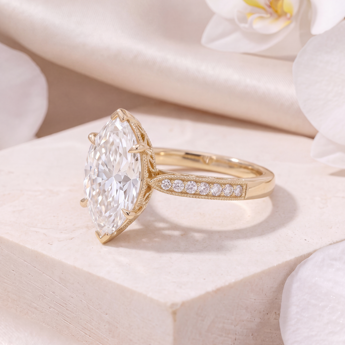 Side angle view of the yellow gold marquise moissanite engagement ring highlighting the side gallery and band details.