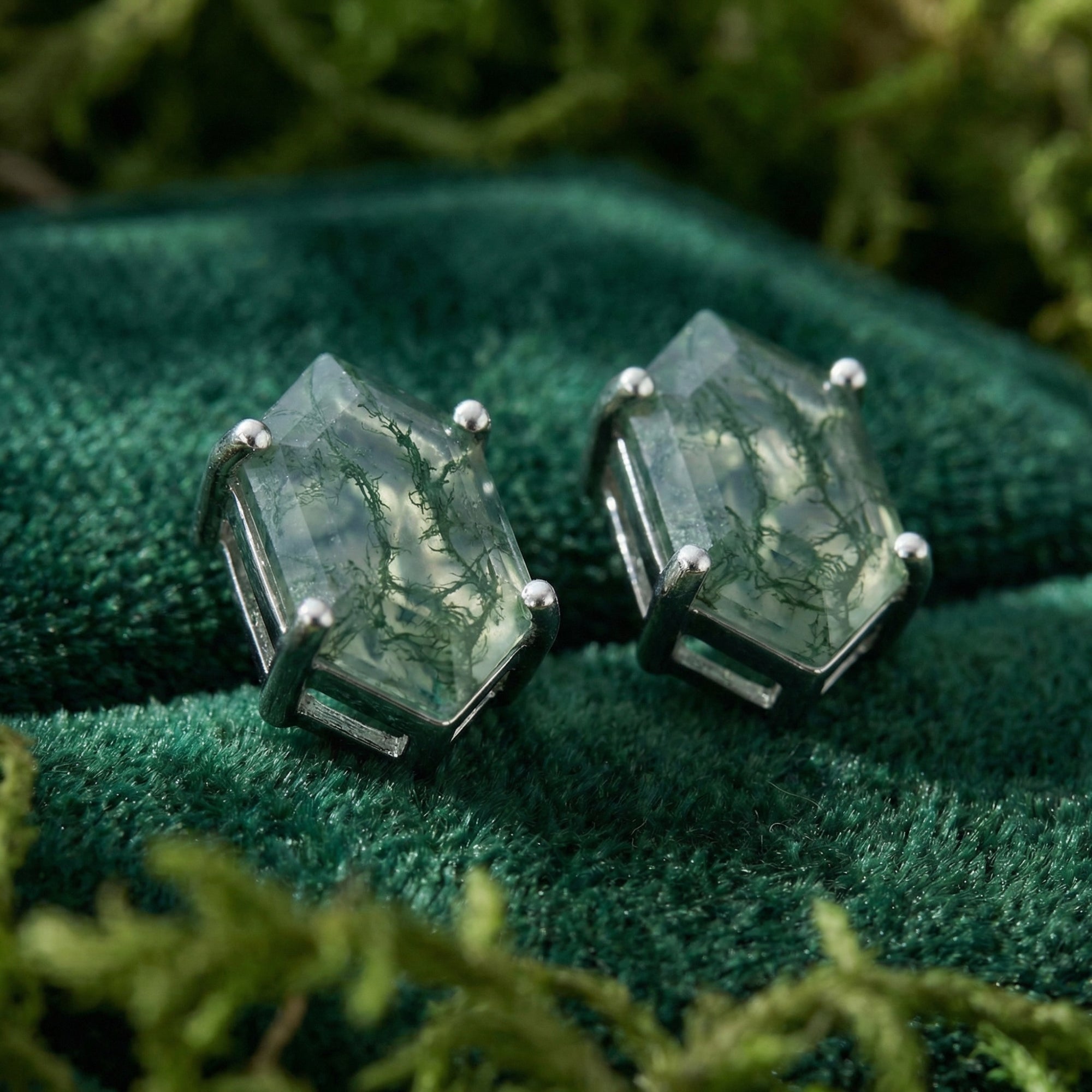 Close-up of coffin cut moss agate stud earrings in S925 sterling silver showing unique green inclusions.