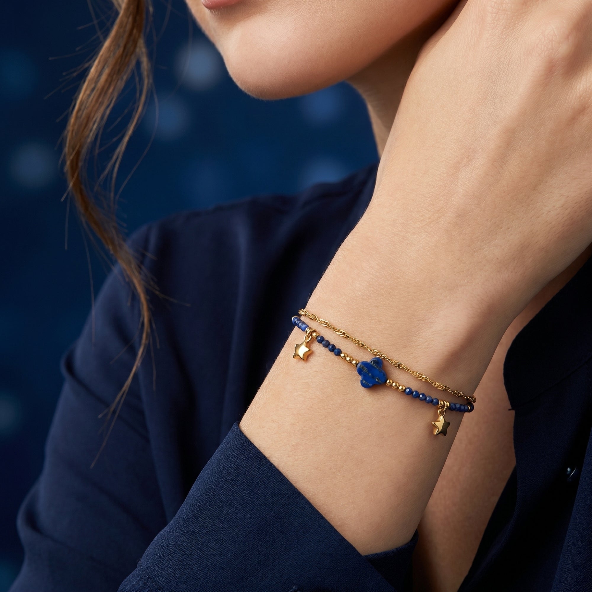 Woman wearing the Serene Horizon gold plated stainless steel bracelet with 3mm natural lapis beads on her wrist.