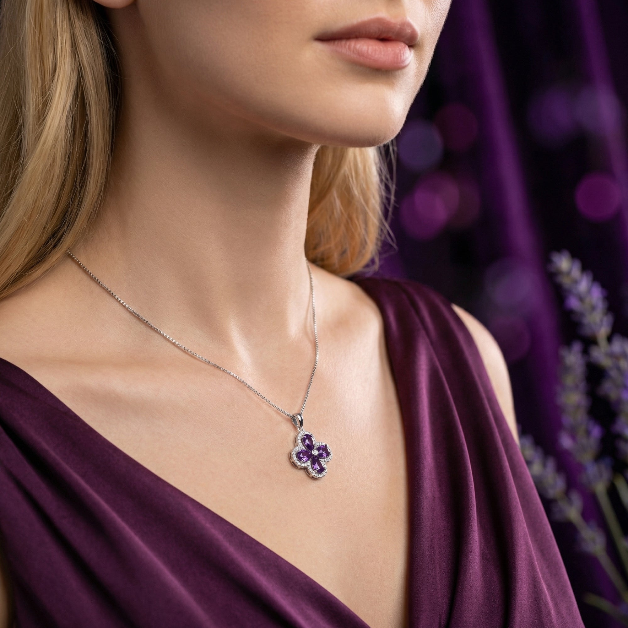 Side view of a model wearing the Visteria amethyst floral pendant in sterling silver.