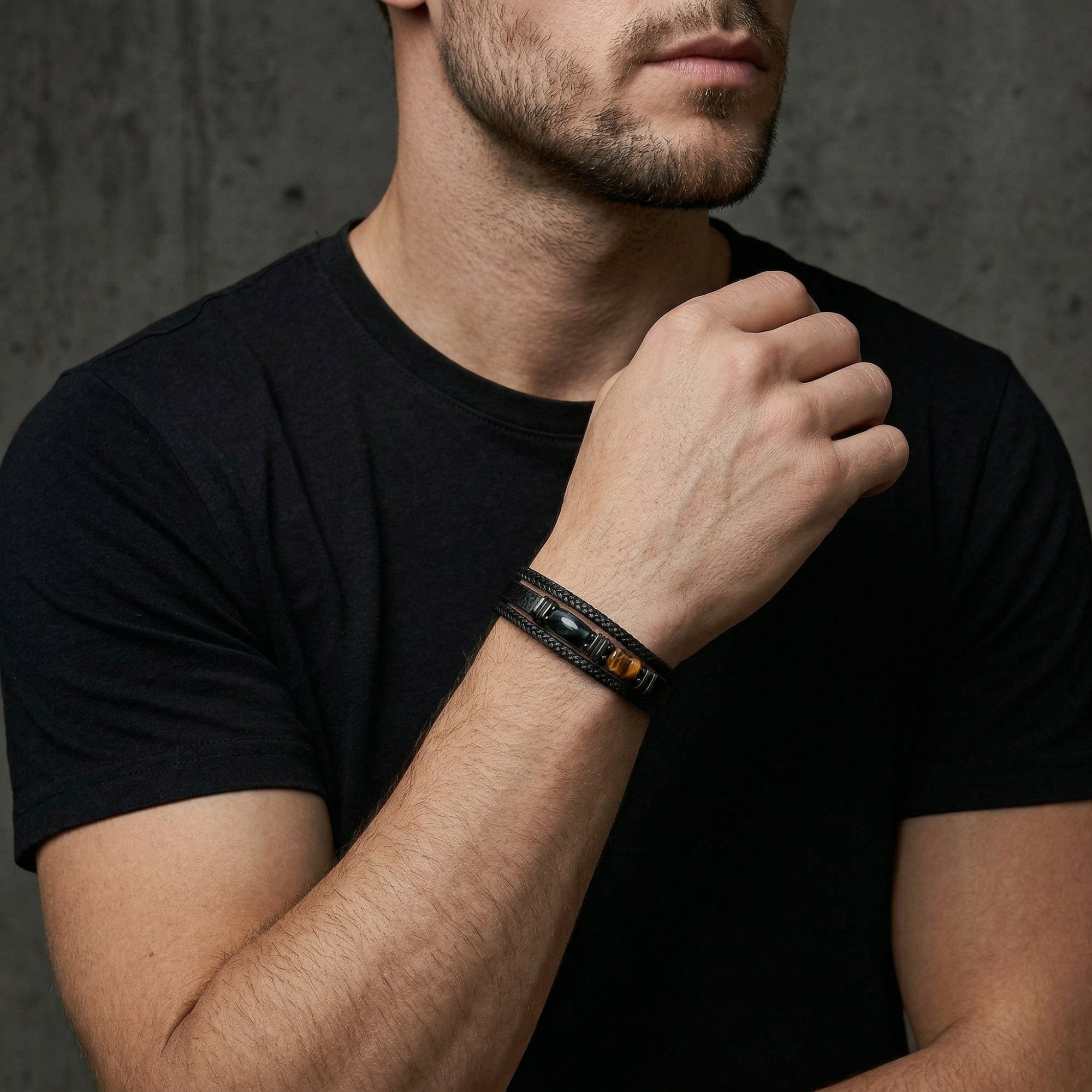 Man wearing the black leather Citadel bracelet with tiger's eye stone and black hardware, torso view.