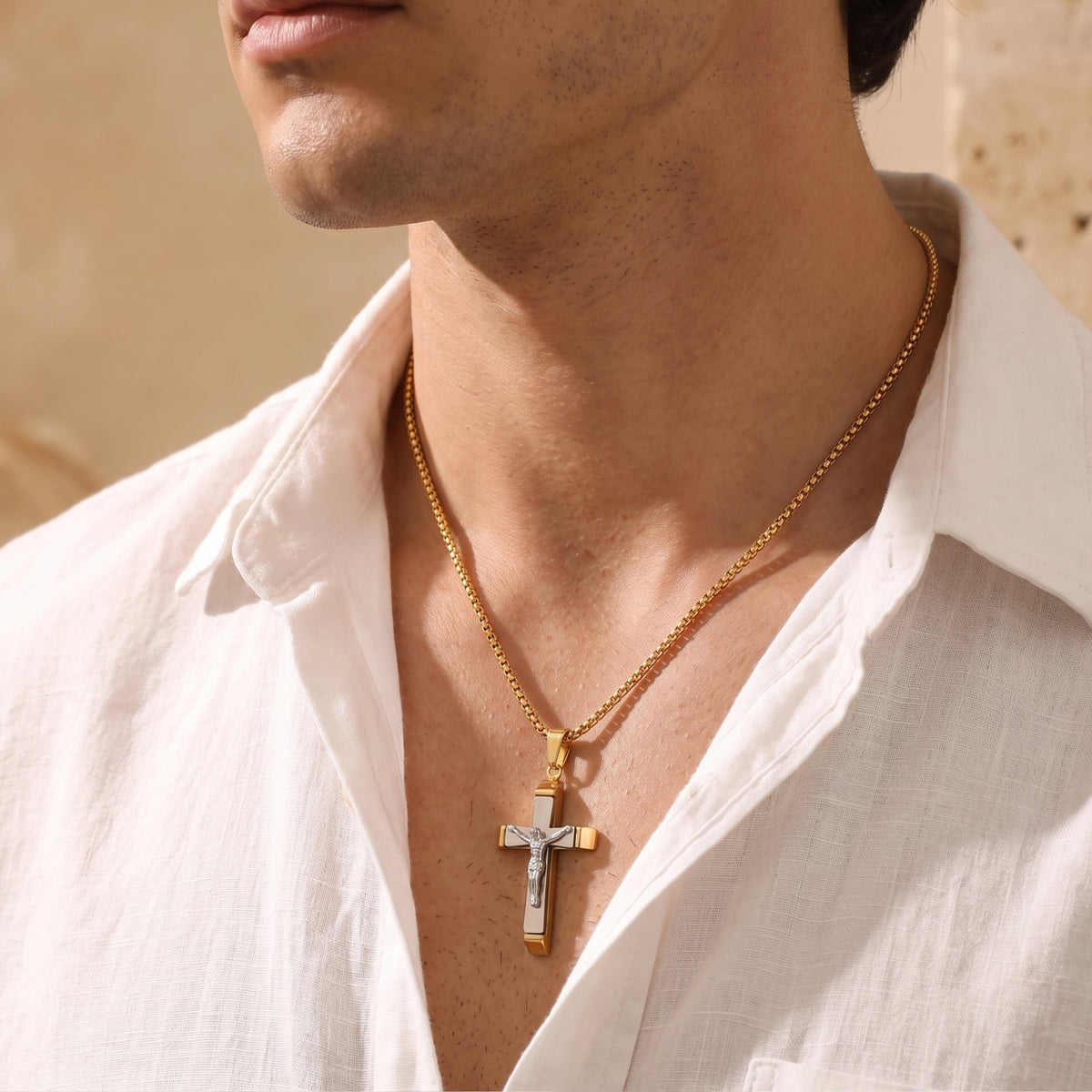 Side-profile view of a person wearing the layered crucifix pendant and gold-tone chain with an open white collar.