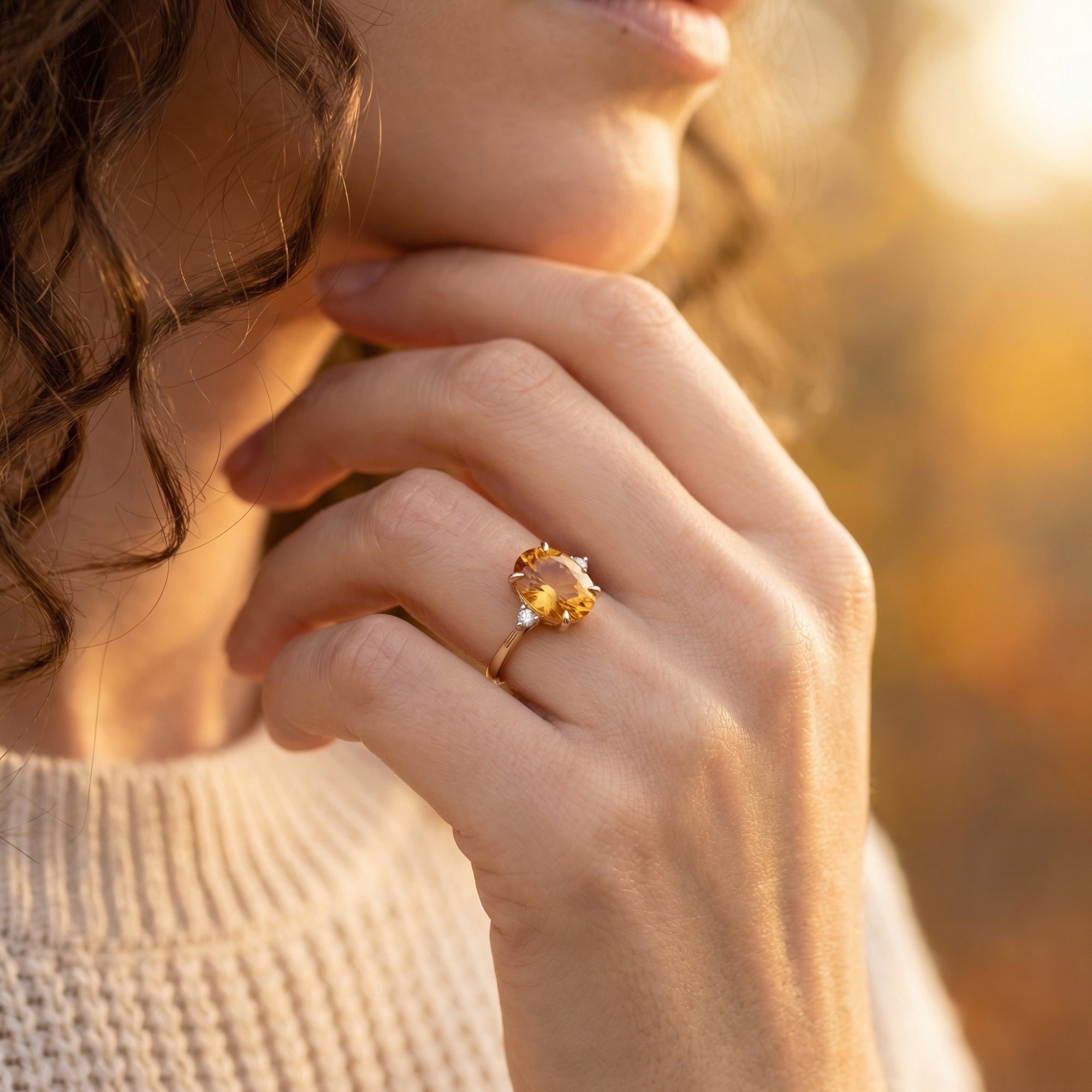 Model wearing the 18K yellow gold Solarienne ring featuring a large oval-cut natural citrine gemstone.