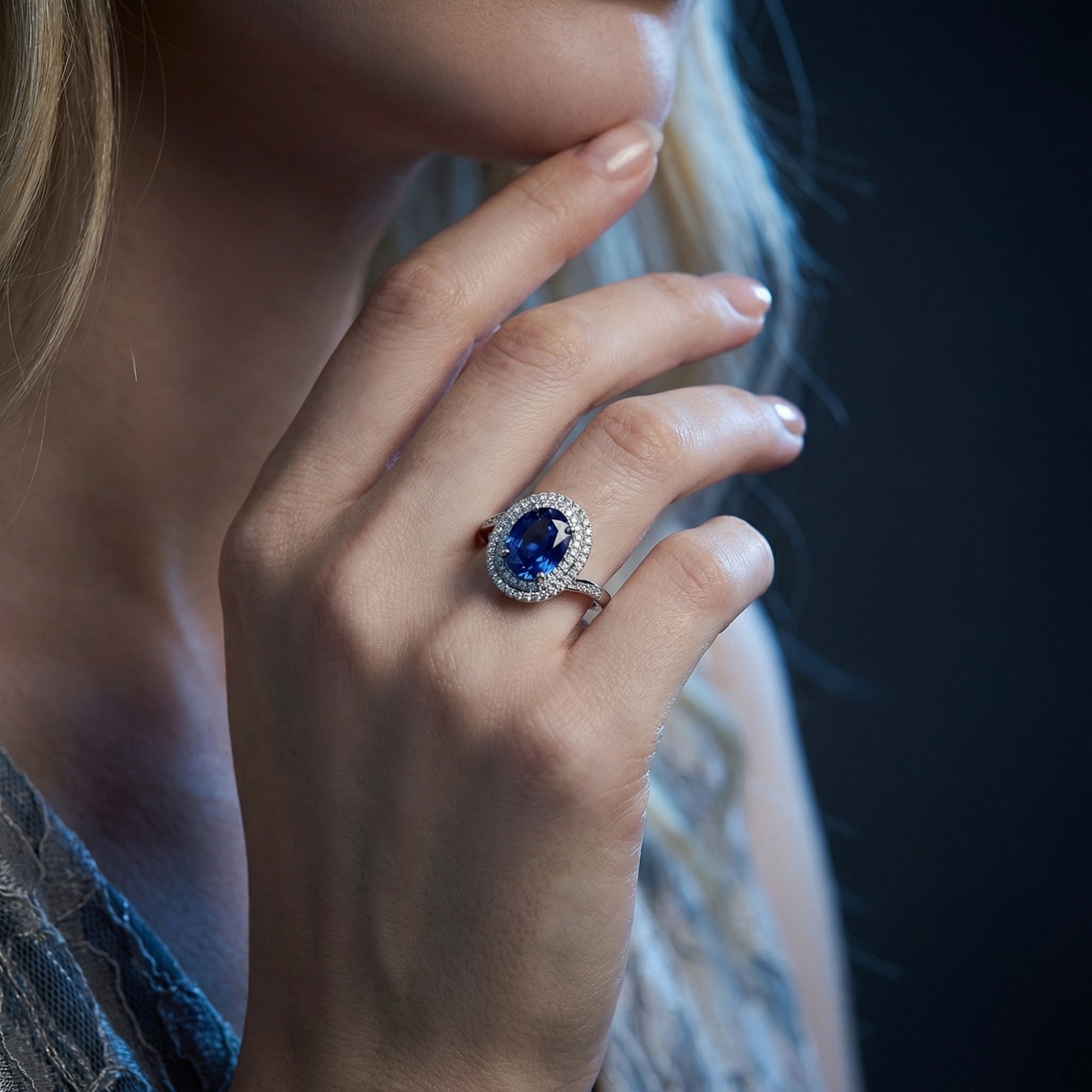 Model wearing the oval cut tanzanite double halo ring in 925 sterling silver, showcasing its size on the hand.