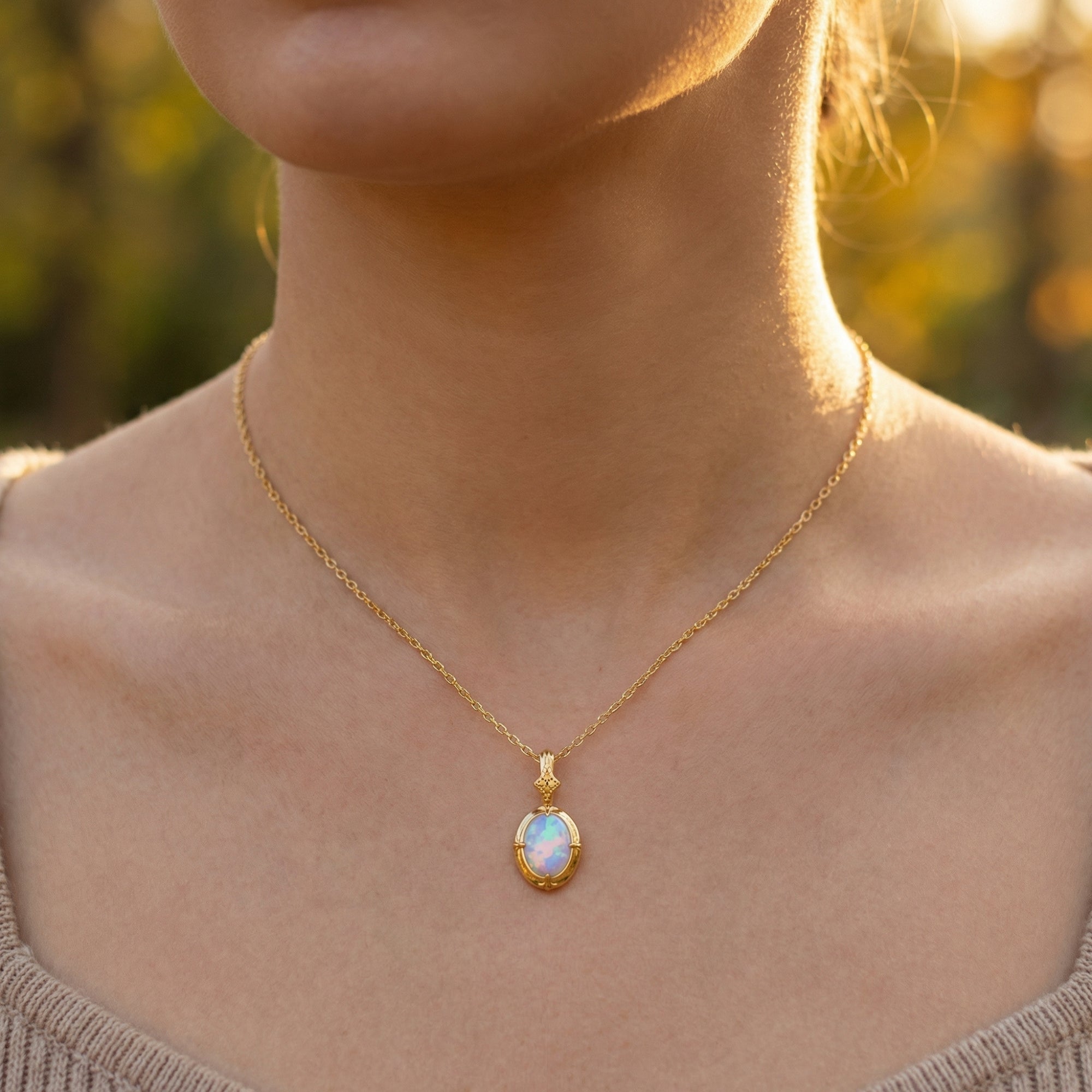 Front view of a model wearing the gold-tone oval white opal pendant necklace.