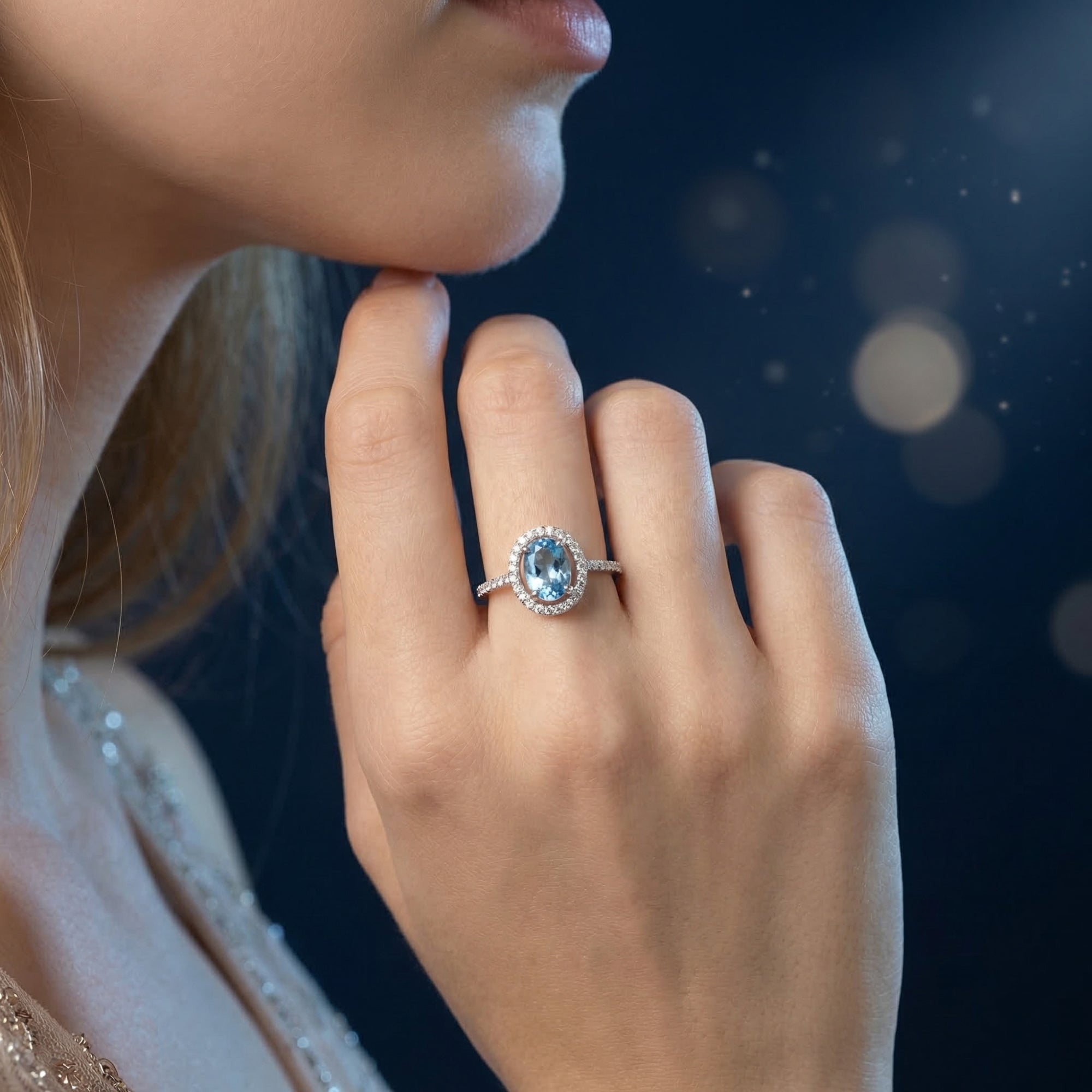 Model wearing the Odellina oval blue topaz sterling silver ring on her finger, showcasing its size and brilliance.