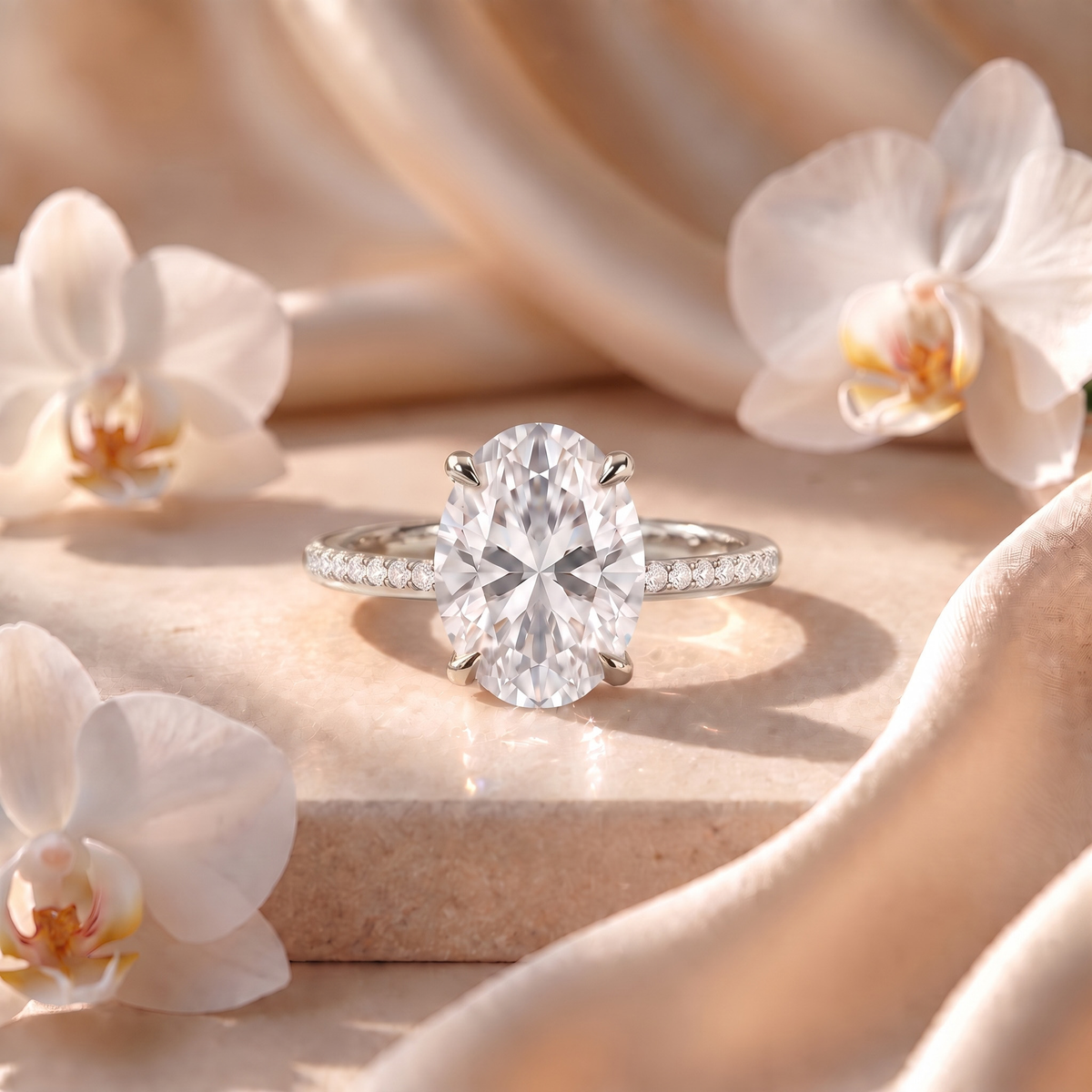 Front view of the oval moissanite engagement ring with a pavé band set in white gold.