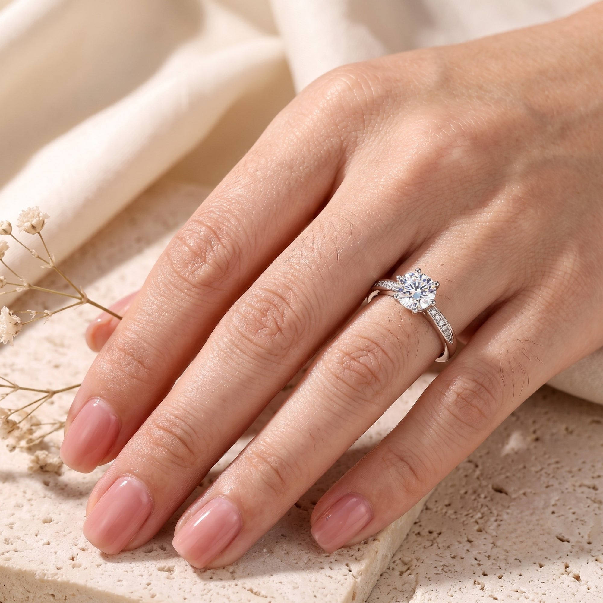 Silver 6.5mm cubic zirconia ring on a hand for scale reference.
