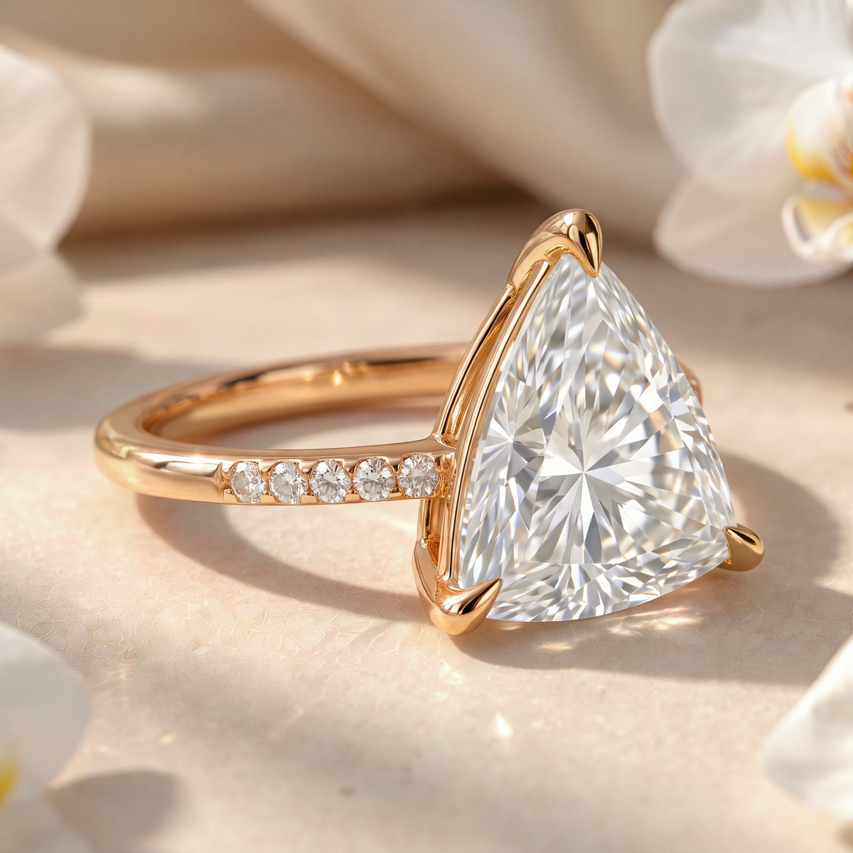 Side view angle of a yellow gold trillion-cut moissanite engagement ring.