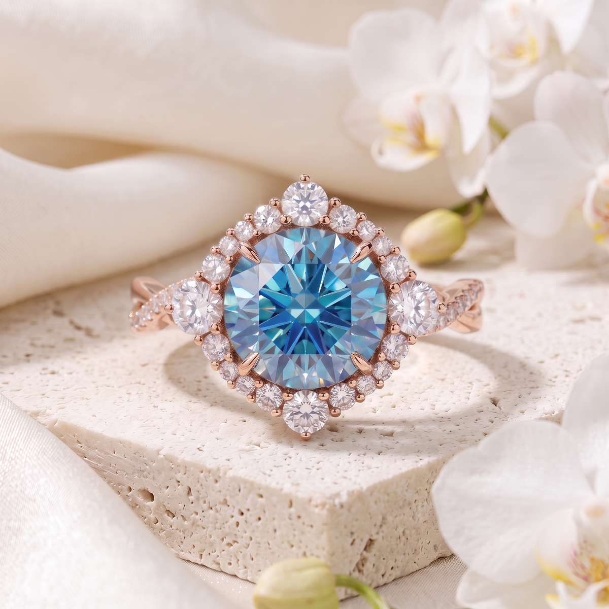 Front view of a rose gold blue moissanite halo ring featuring an ornate diamond-halo border.