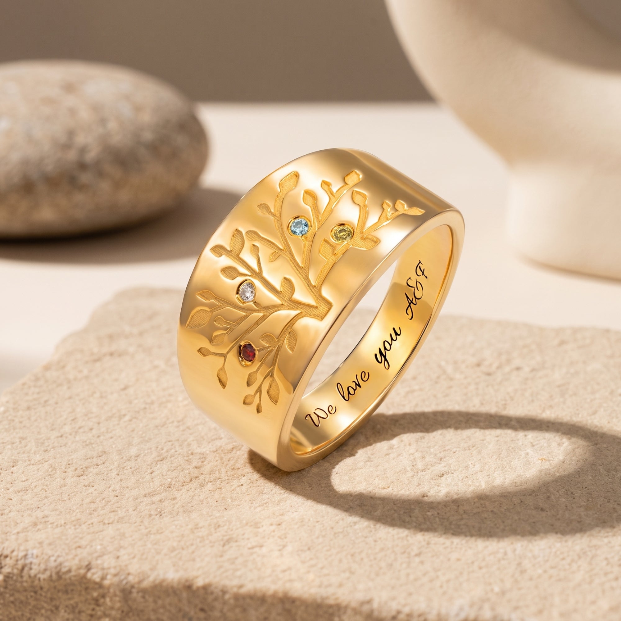 Solid gold ring with a detailed family tree design and simulated birthstones.