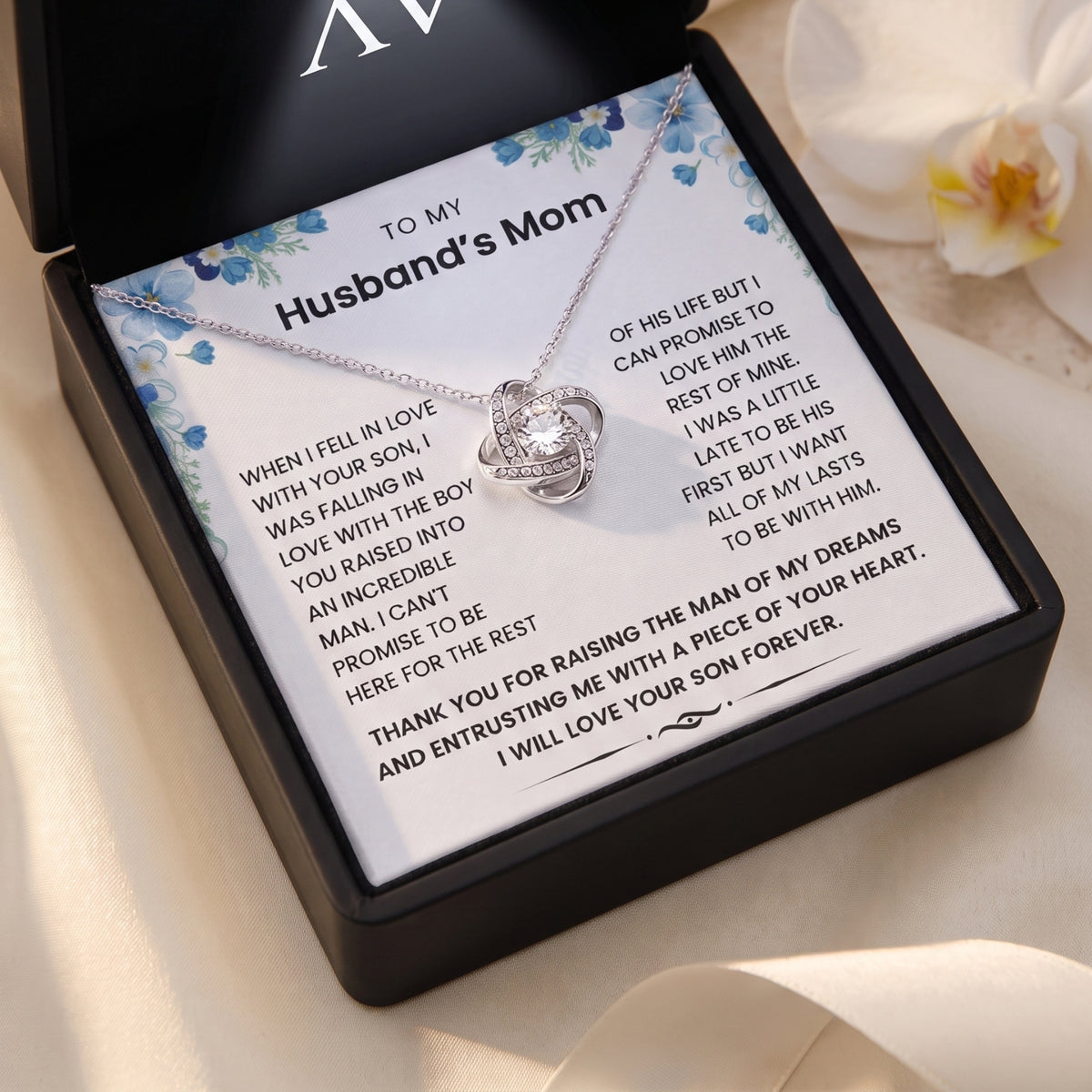 Silver-finish love knot necklace and the full To My Husband’s Mom message card in an Awareness Avenue black gift box.