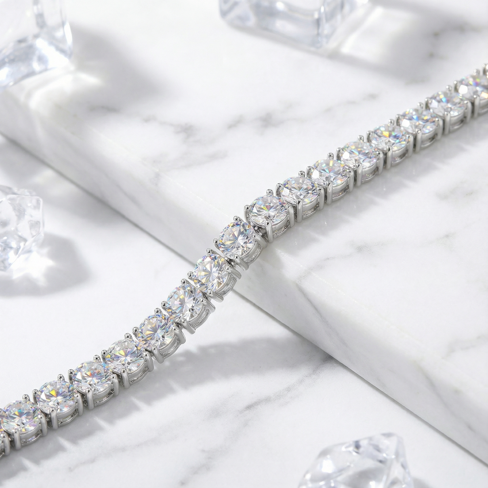 Macro view of round zirconia stones in a silver stainless steel prong setting on the Aris tennis bracelet.